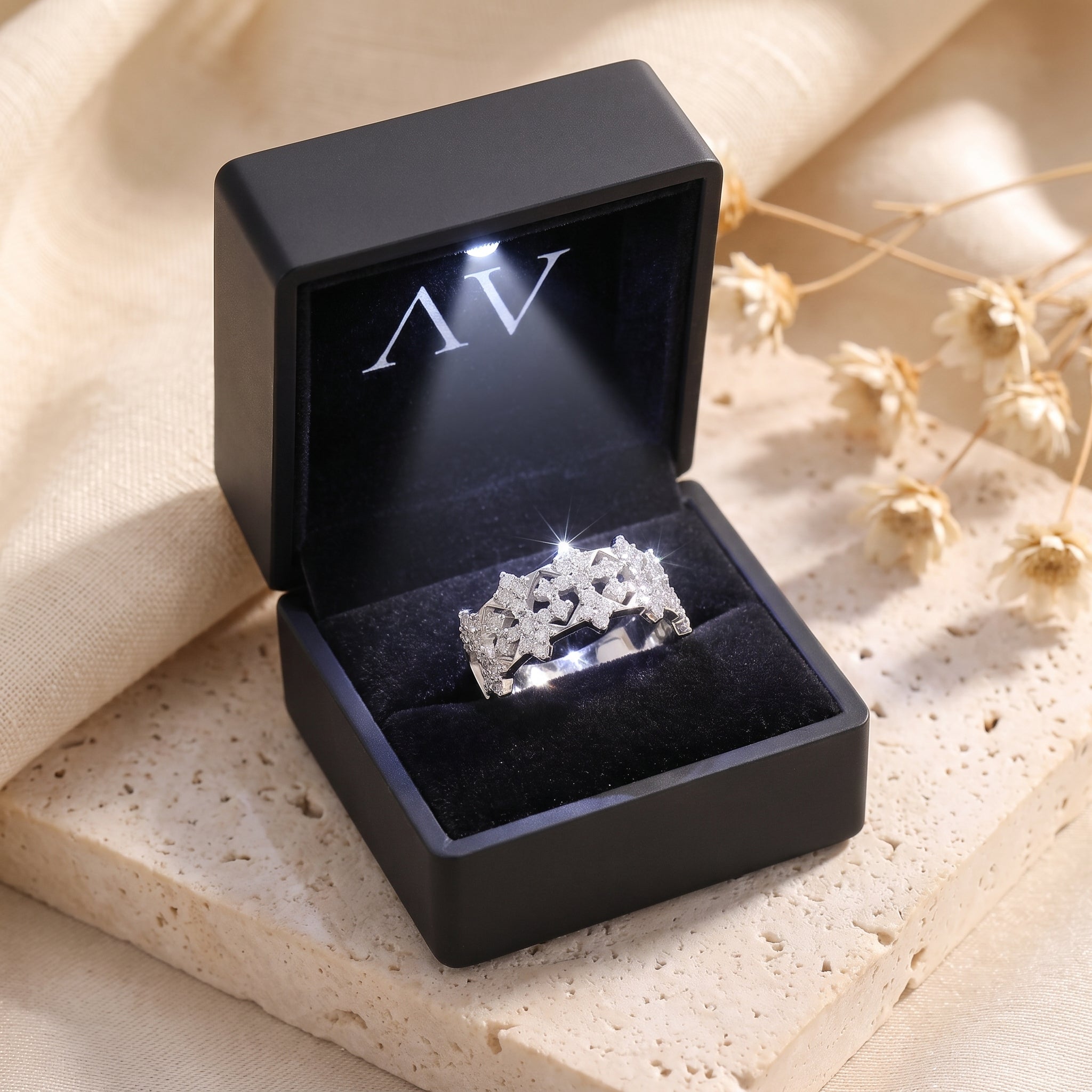 Sterling silver snowflake crown ring with simulated diamonds in a black LED gift box.