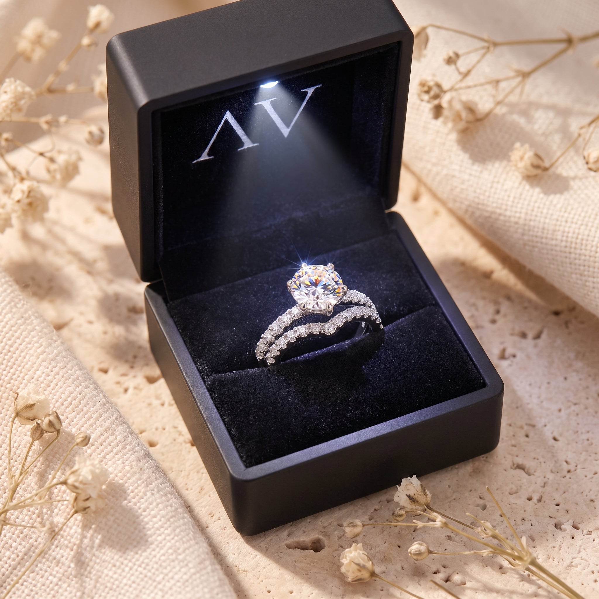 Silver Amariel ring set with round simulated diamond inside a black LED-lit jewelry box.