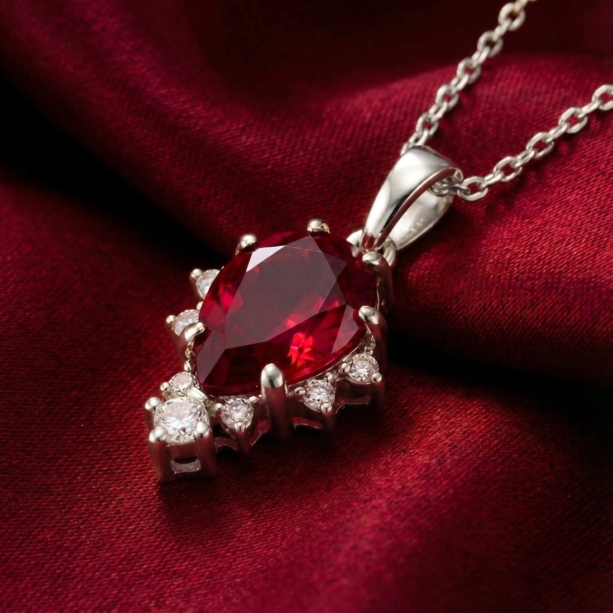 The Mirellia pear cut simulated ruby necklace in solid white gold.