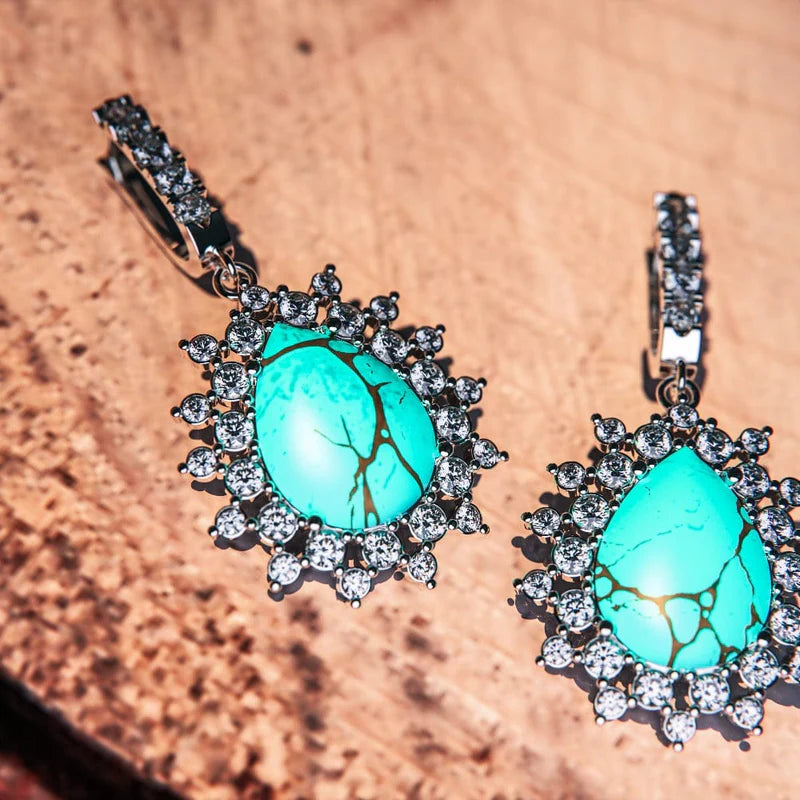 Frontal close up image of a pair of turquoise earrings called "Blue Lagoon" from Awareness Avenue