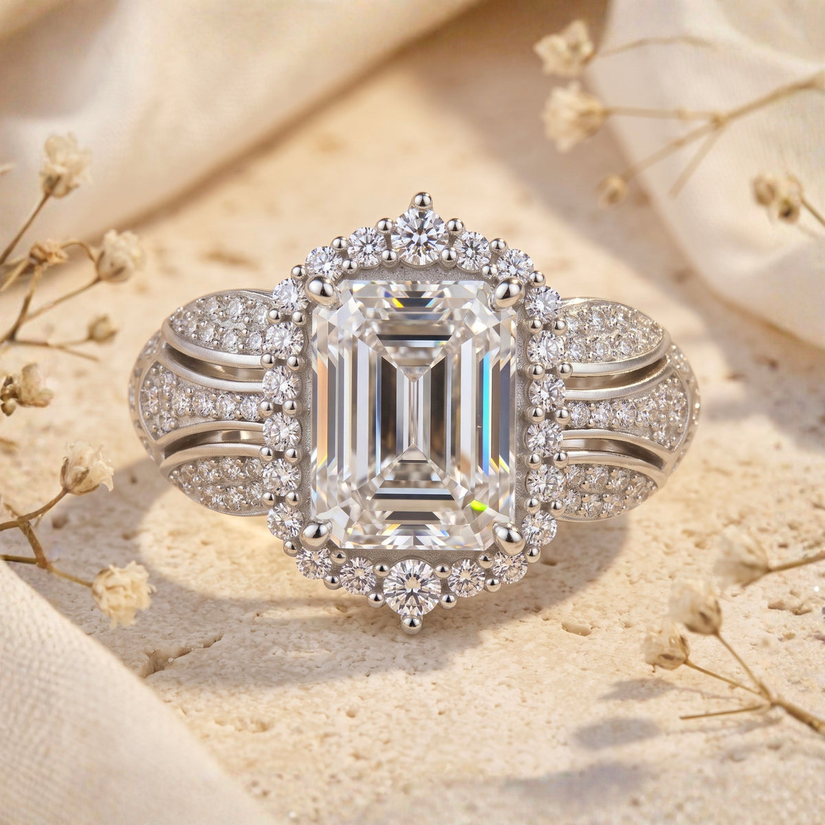 Front view of the silver halo ring featuring a large emerald-cut center stone and pavé-set split band.