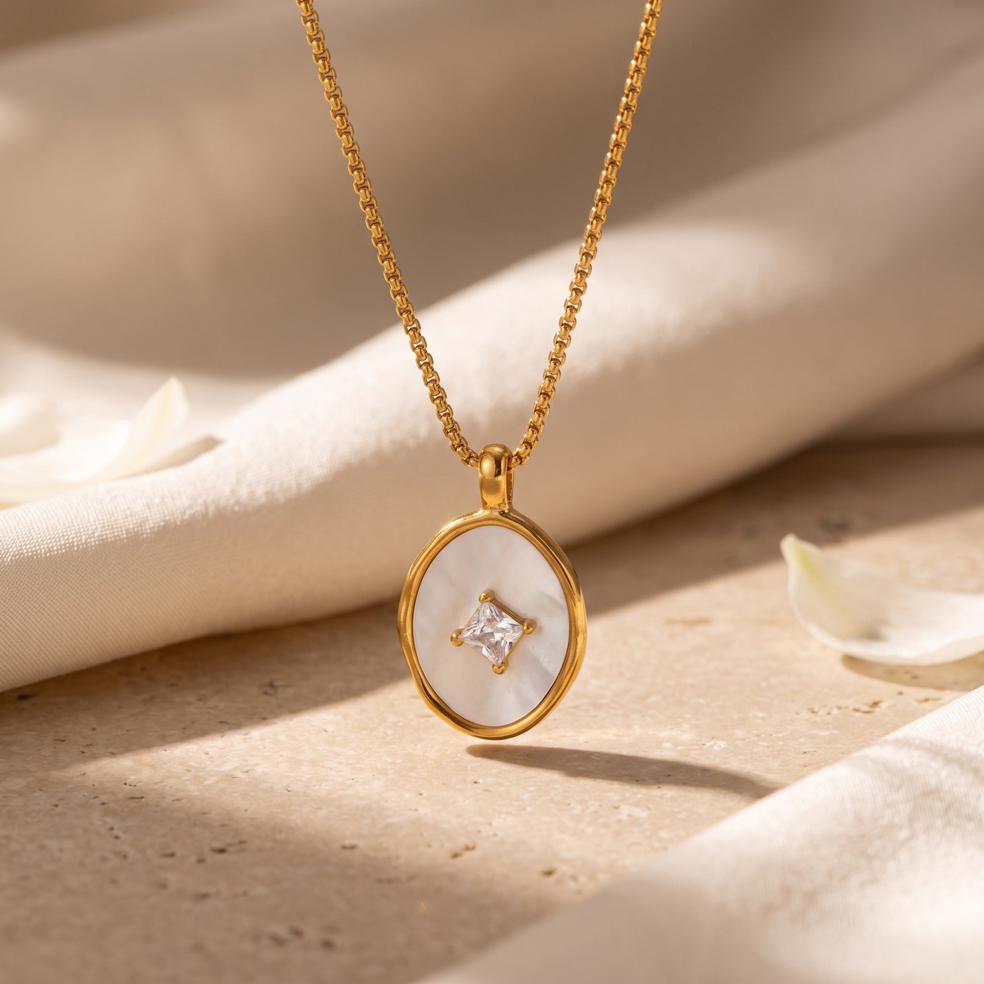 18K gold Lucelle necklace with mother of pearl and princess-cut diamond pendant in a detailed lifestyle close-up.