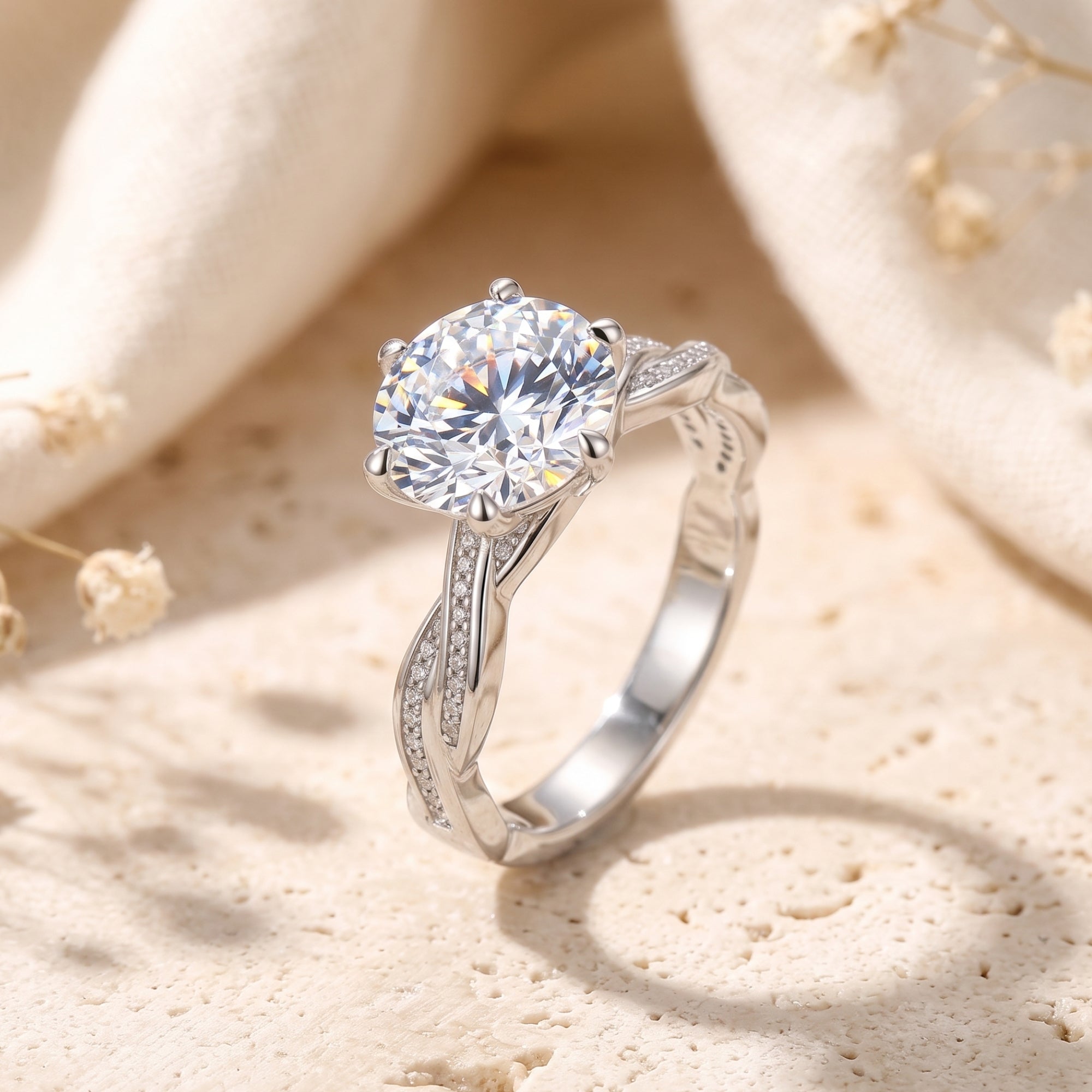 Round-cut simulated diamond ring in S925 sterling silver with a twisted pavé band on a stone surface.