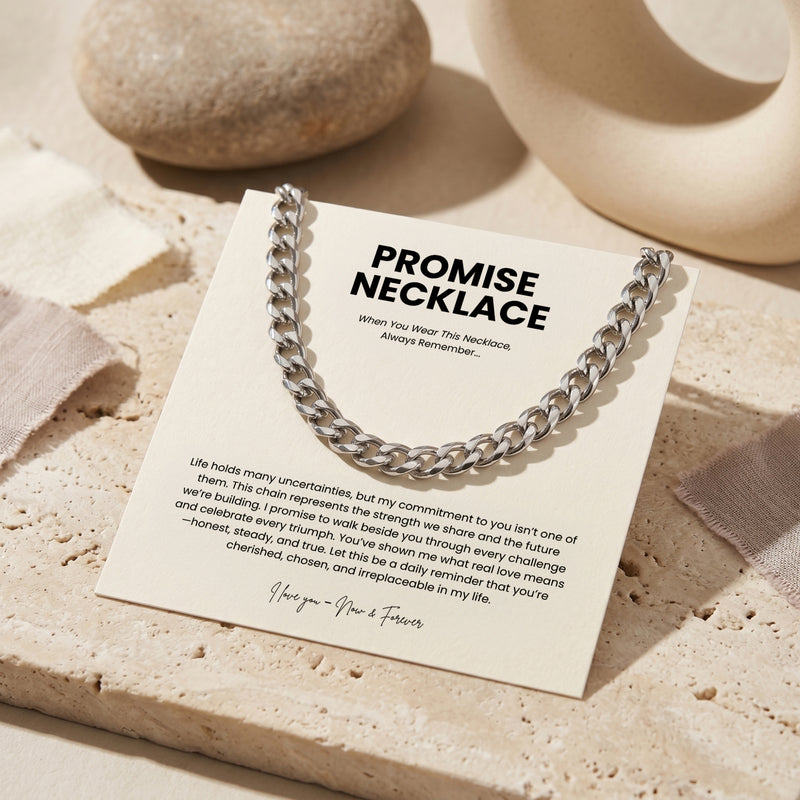 Silver Cuban link chain displayed on a Promise Necklace message card resting on a stone slab.