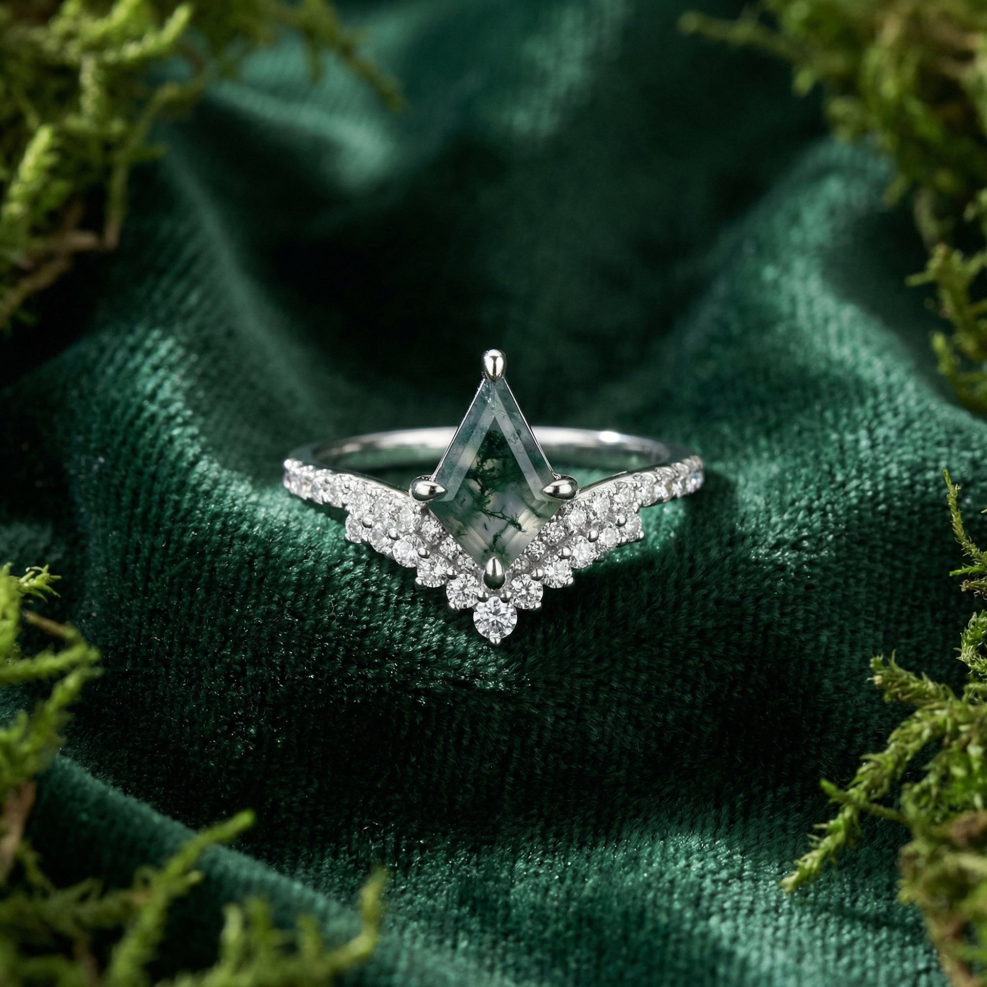 Kite cut moss agate ring in S925 sterling silver with diamond accents, displayed on green velvet with moss.