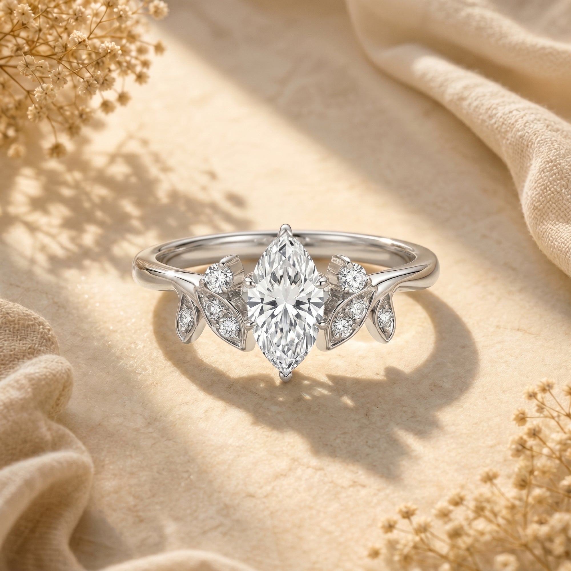 Marquise moissanite silver ring with leaf accents on a neutral lifestyle background.