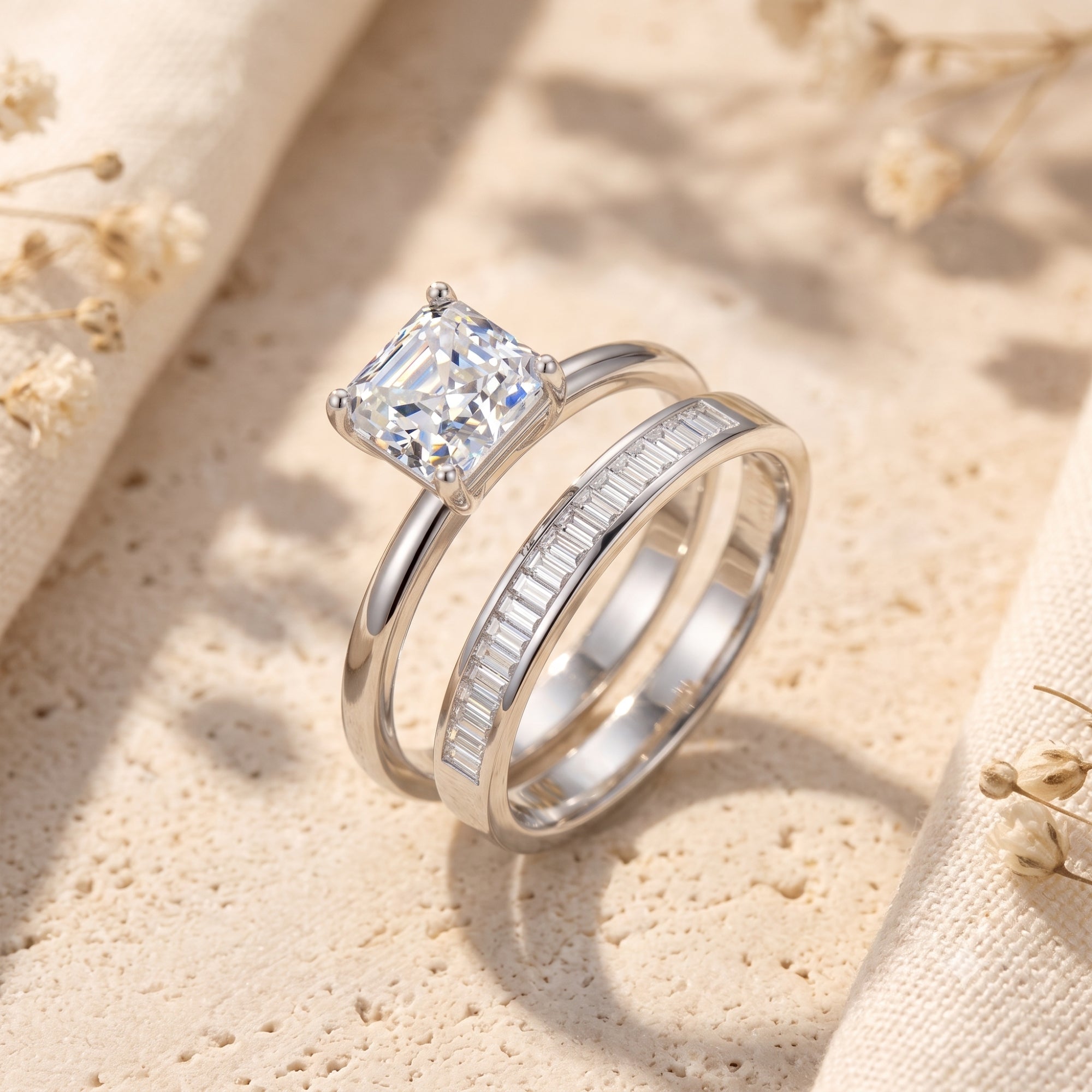 Silver Liorienne ring set with a square-cut simulated diamond and baguette eternity band on a styled stone surface.