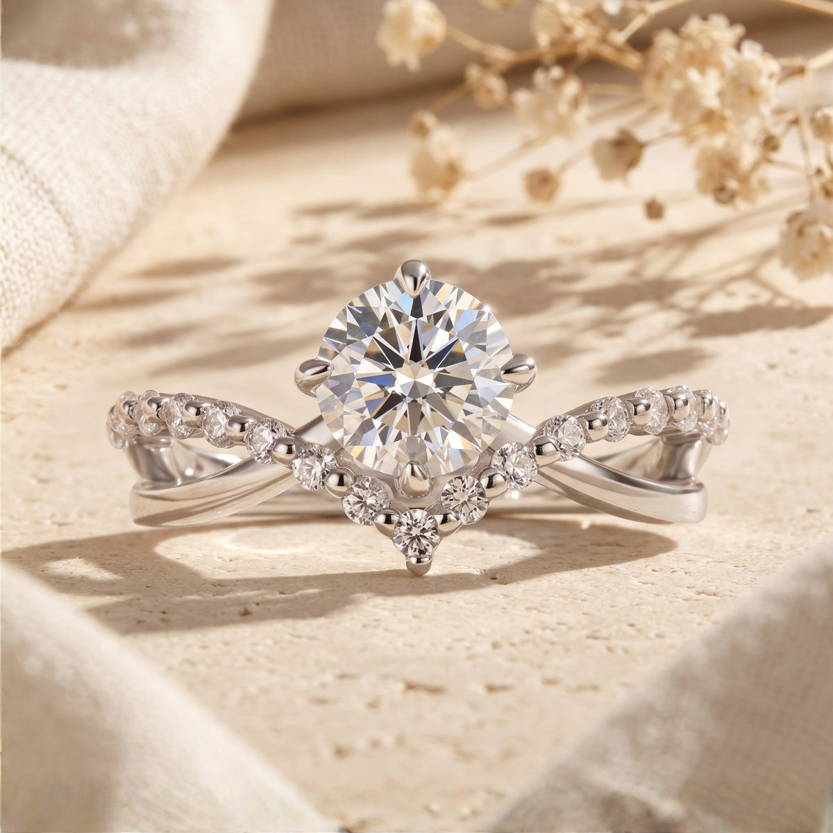 Front view of a silver chevron split band ring with a round center stone and pave-set accent band.