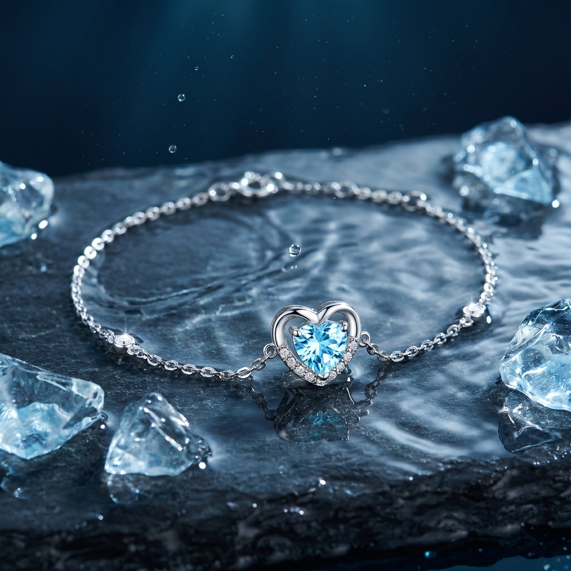 Heart cut aquamarine platinum bracelet displayed on a dark wet stone with ice cubes and water droplets.