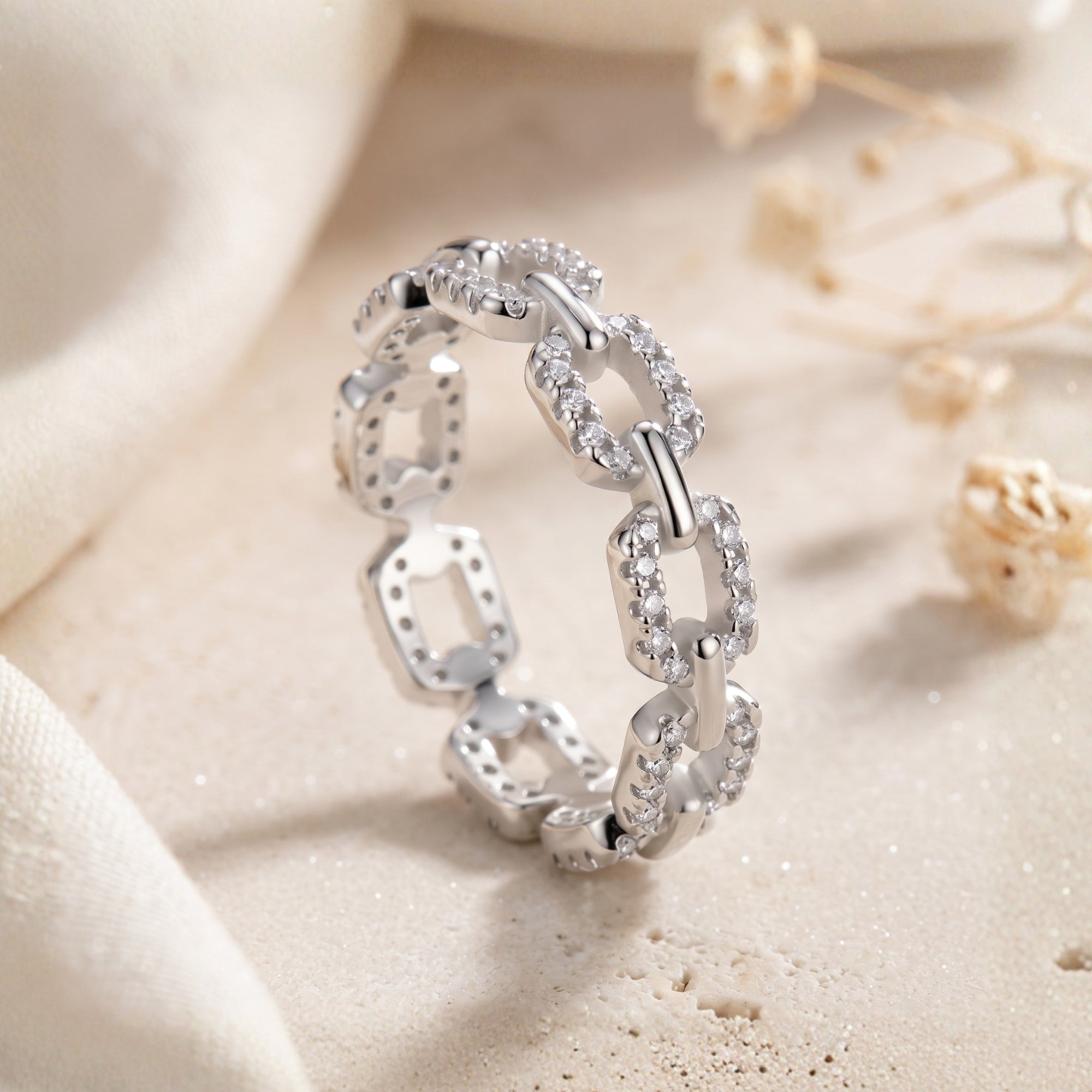 S925 silver pavé link ring with simulated diamonds on a neutral background.
