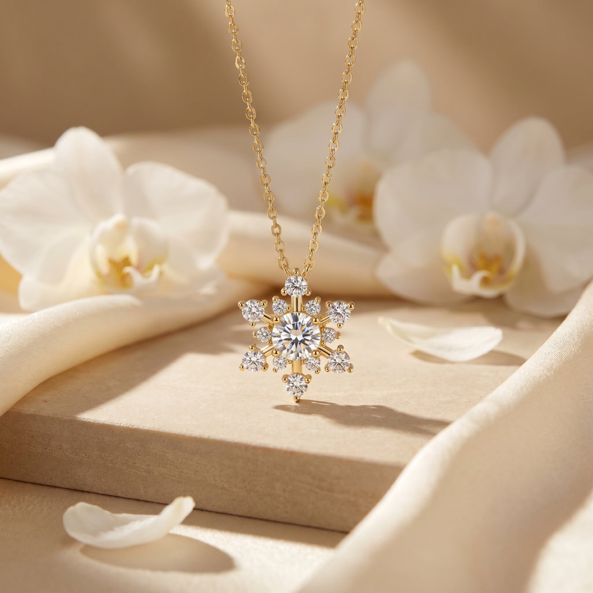 Yellow gold snowflake pendant with round moissanite stones on a floral lifestyle background.