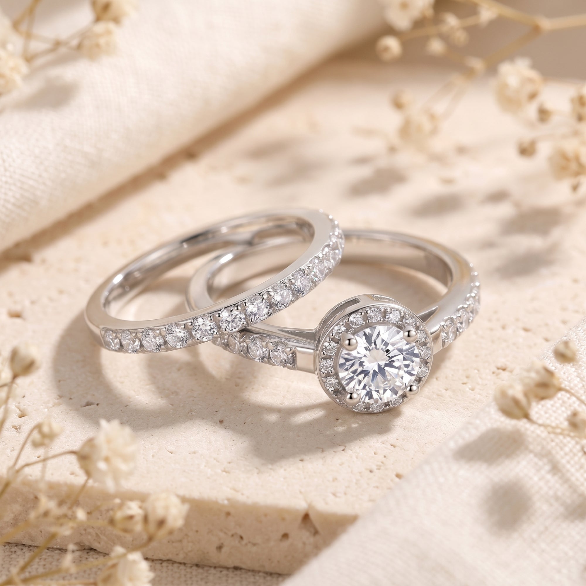 Myrella sterling silver halo ring set with round cut simulated diamond on stone with dried flowers.