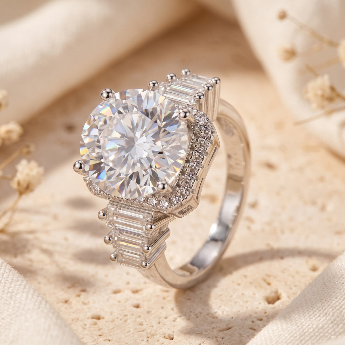 Angled close-up of a silver ring featuring a large round center stone, cushion halo, and baguette side stones.