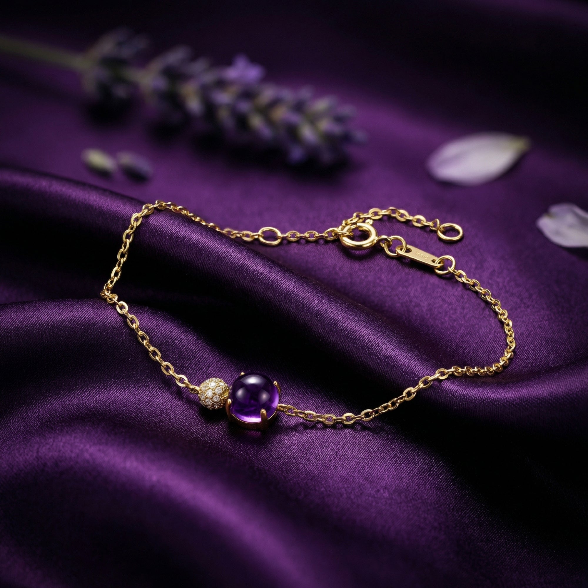 18K yellow gold Veraline bracelet with a round cut natural amethyst on purple silk fabric with lavender.