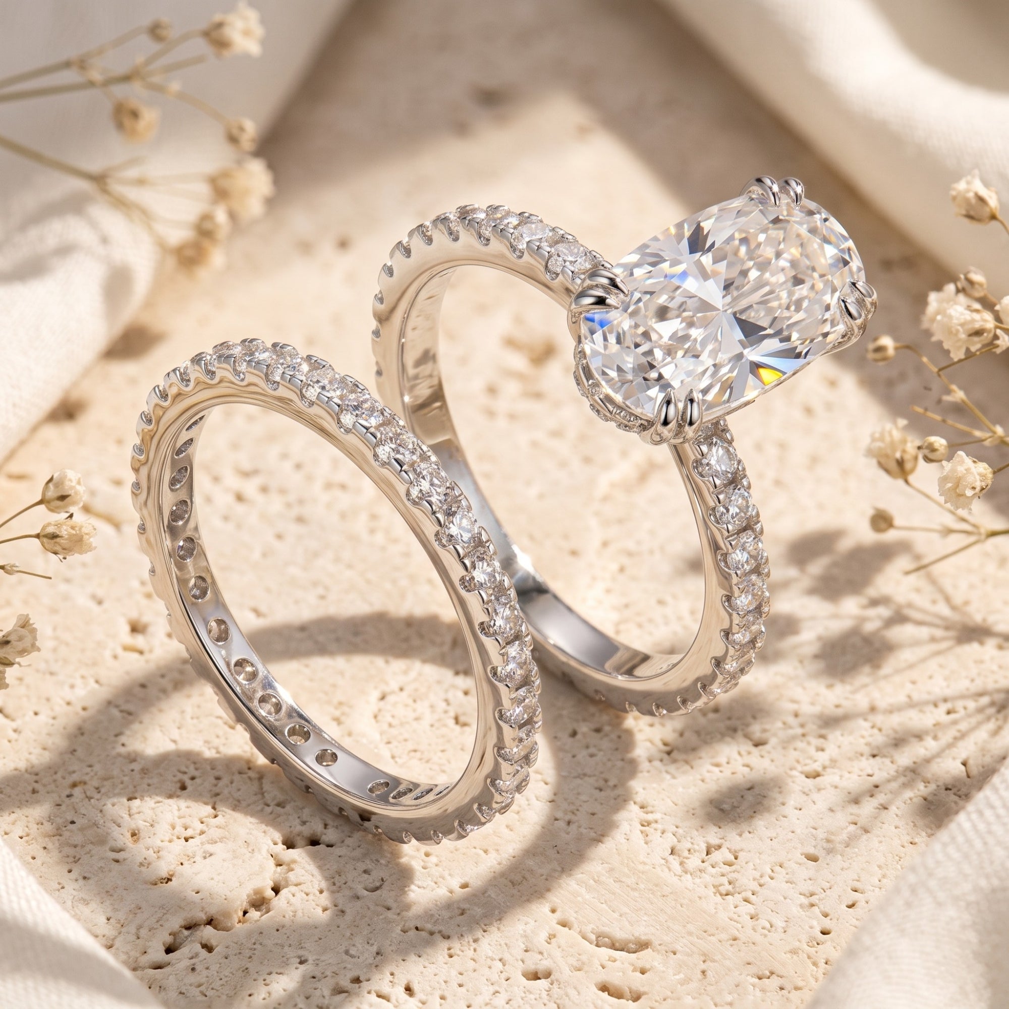 Silver Elysinia ring set with oval-cut simulated diamond on stone with dried flowers.