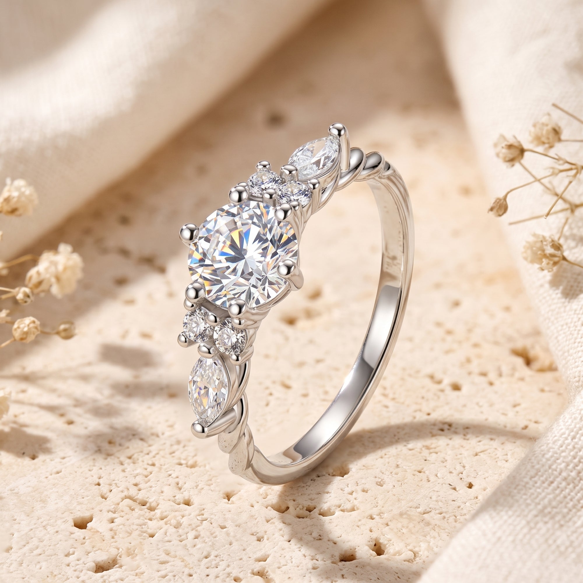 Carlotta silver promise ring with round and marquise simulated diamonds on a textured stone surface.