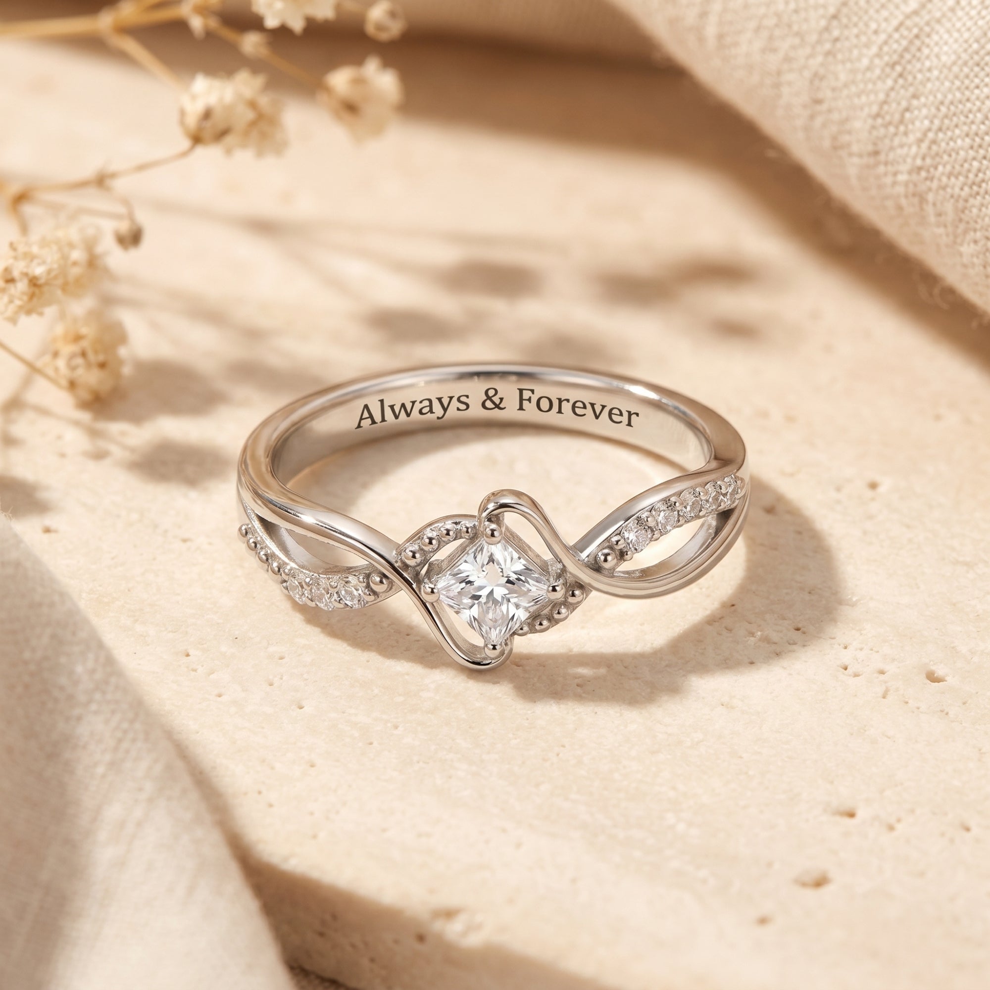 Princess cut moissanite ring in S925 sterling silver with Always & Forever engraving on lifestyle background.