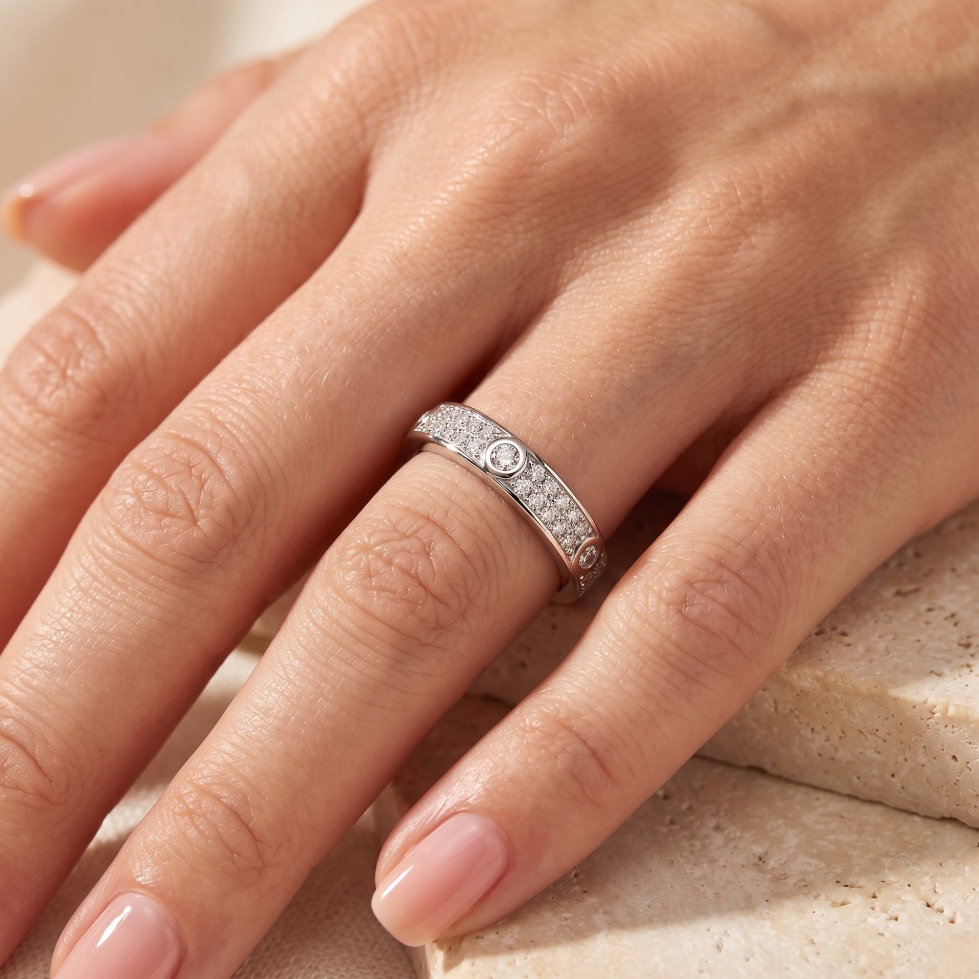 Sterling silver simulated diamond promise ring worn on a model's ring finger.