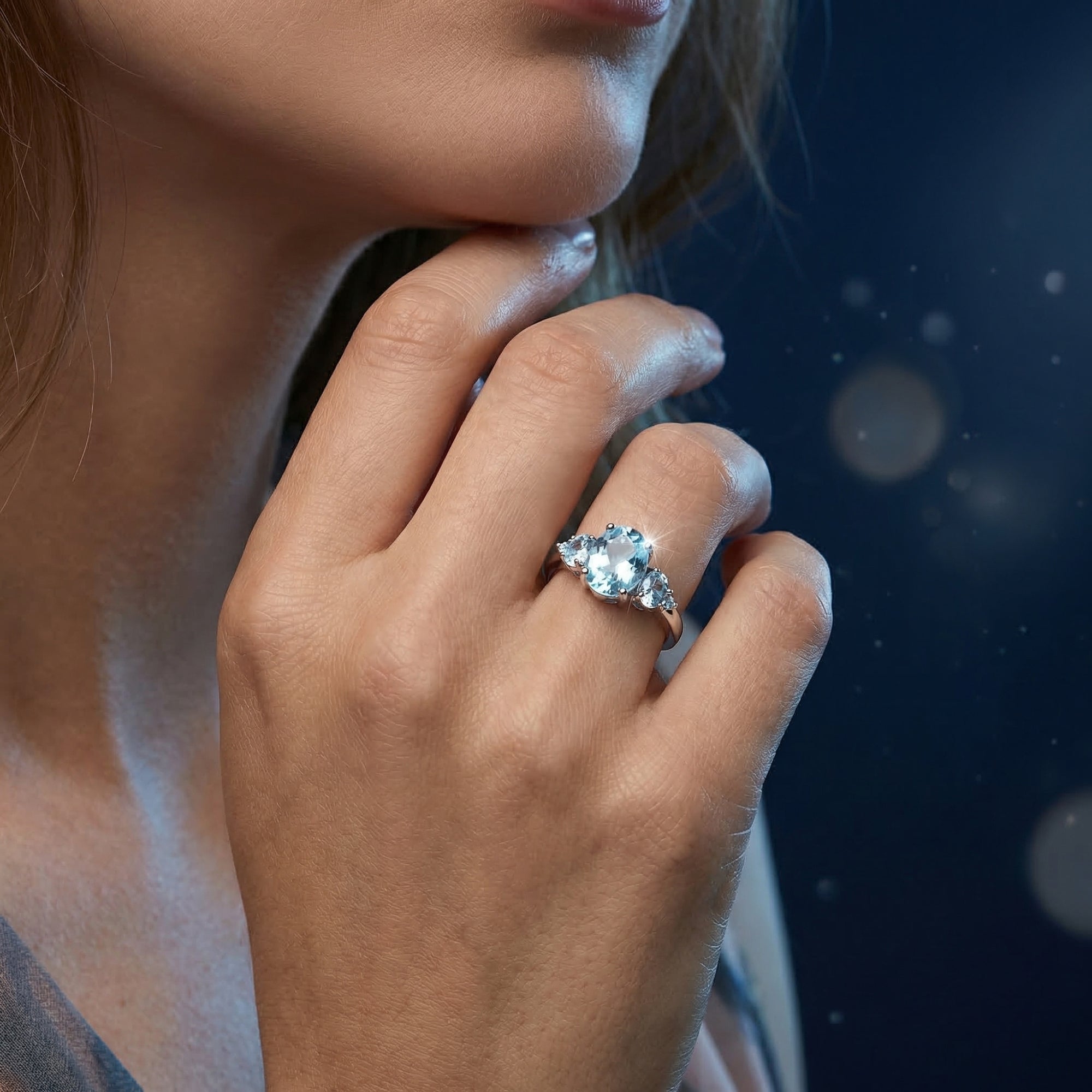 Model wearing the Nereis oval natural blue topaz sterling silver ring on her hand.