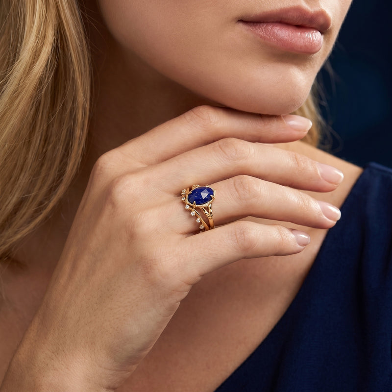 Model wearing the gold plated silver Olympia natural lapis ring and matching curved band on her finger.