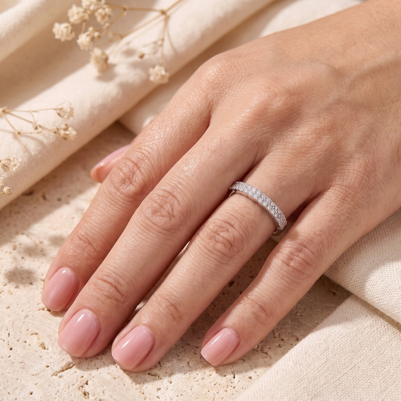 Sterling silver double row pavé promise ring with cubic zirconia worn on a hand.