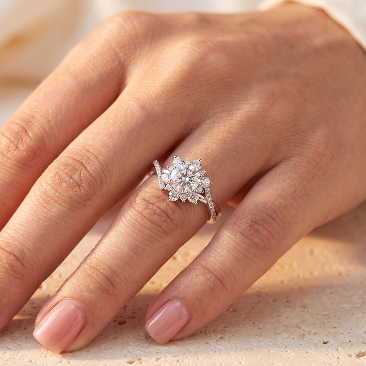Close-up of a hand wearing the silver cluster ring, showing its round center stone and stone-set twisted band.