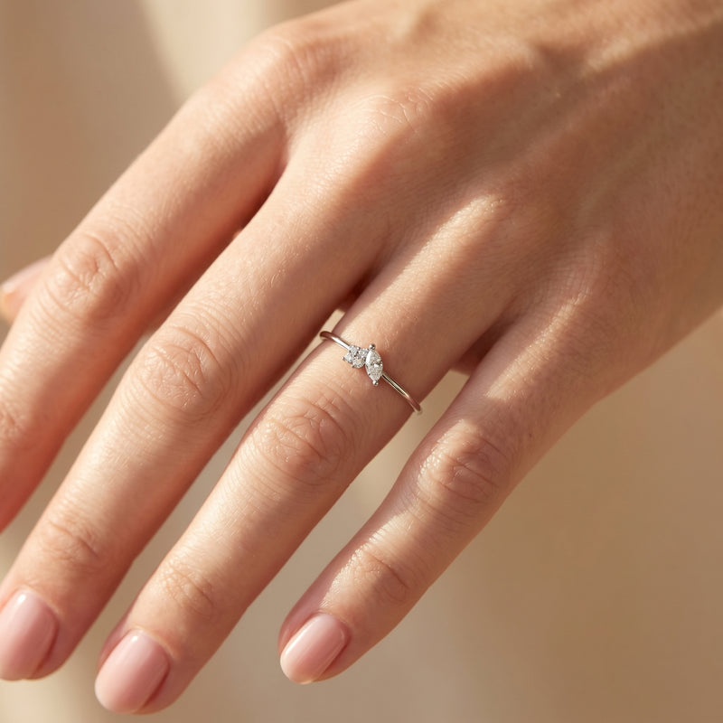 Sterling silver marquise moissanite ring worn on a woman's hand.