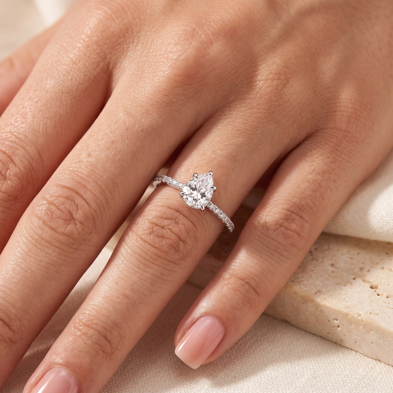 Teardrop simulated diamond ring in sterling silver worn on a woman's ring finger.