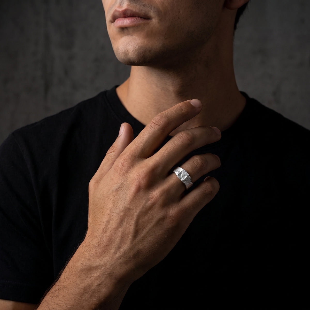 Male model wearing the molten textured silver open ring on his ring finger.