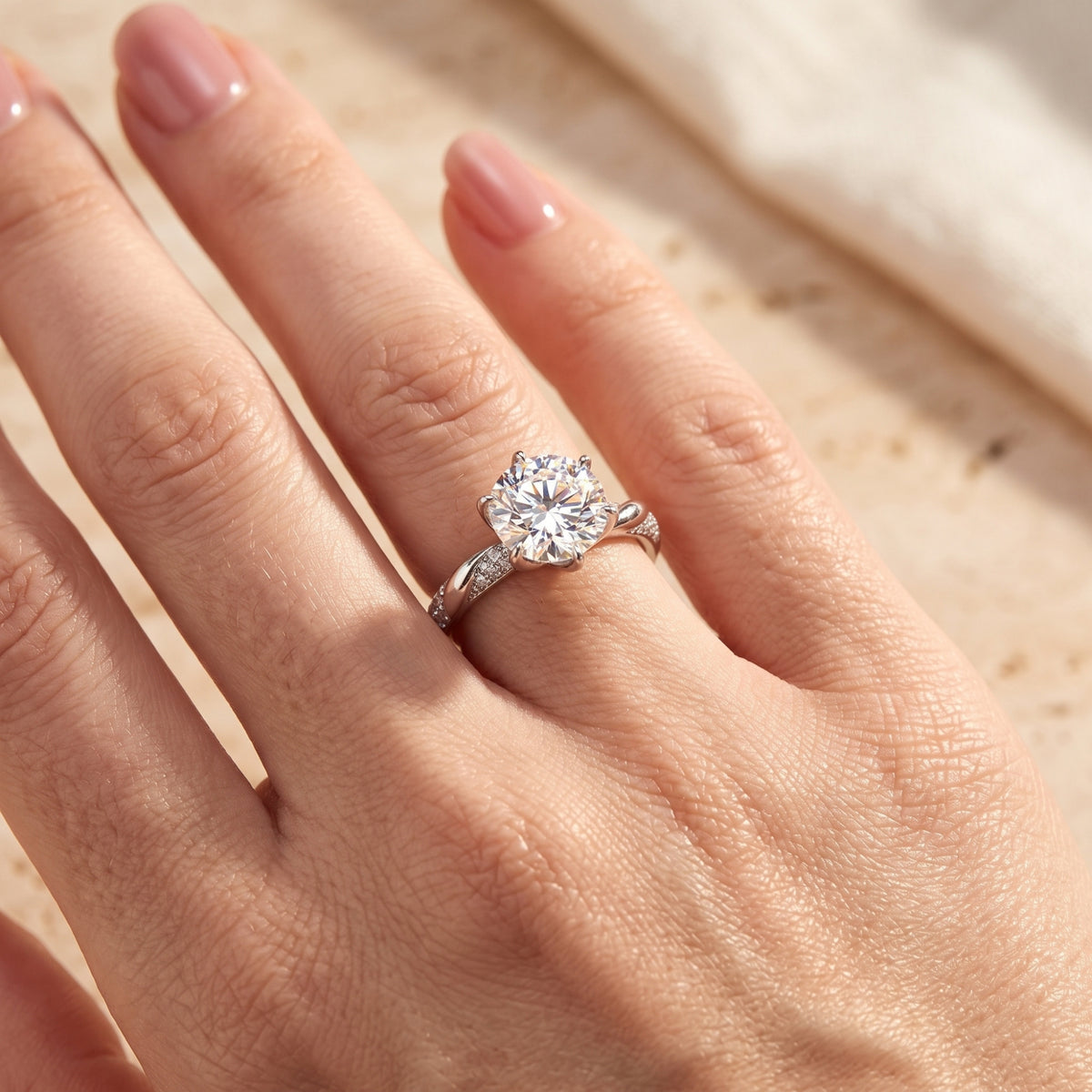 Round cut simulated diamond silver promise ring worn on a model's hand.