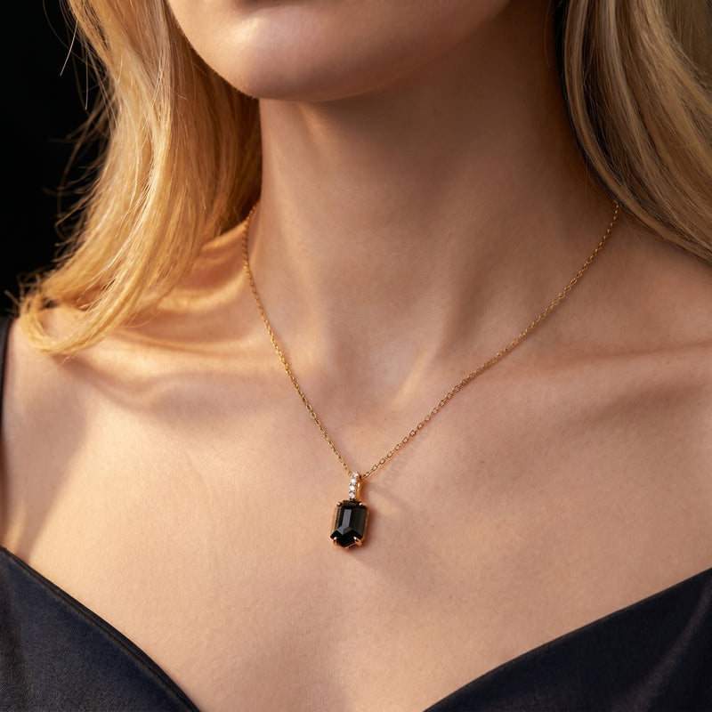 Noctis square-cut black onyx pendant necklace in 18K gold plated silver worn by a model.