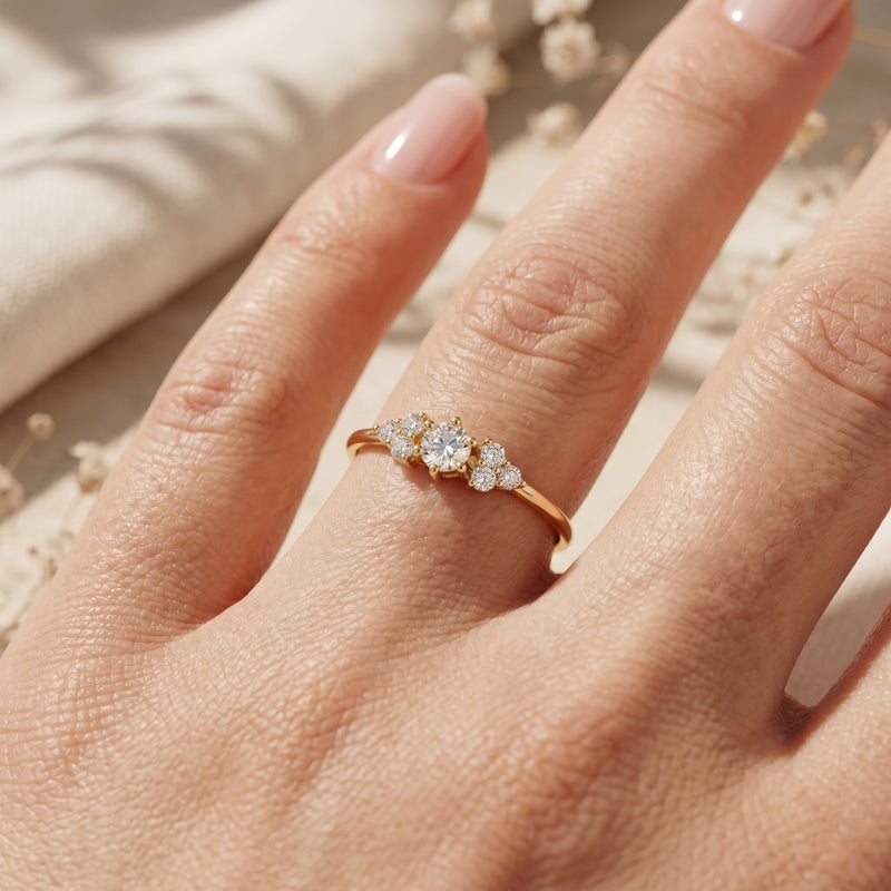 18K gold vermeil Aurestria moissanite ring worn on a woman's finger, showcasing the round cut center stone.