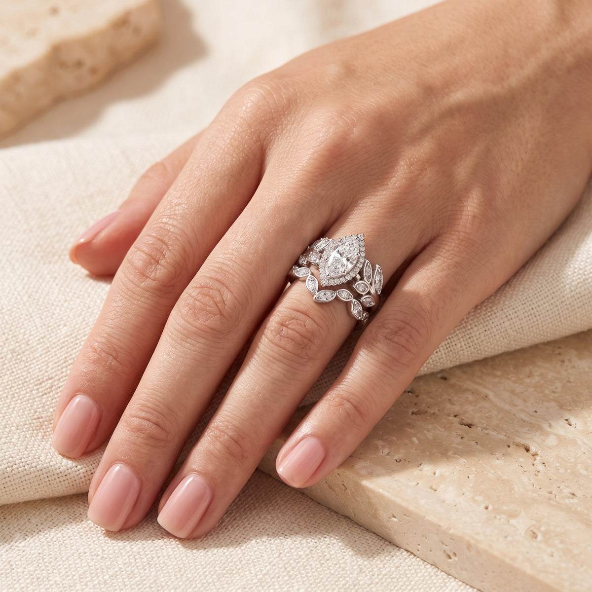 Marquise cut simulated diamond promise ring in sterling silver worn on a hand.