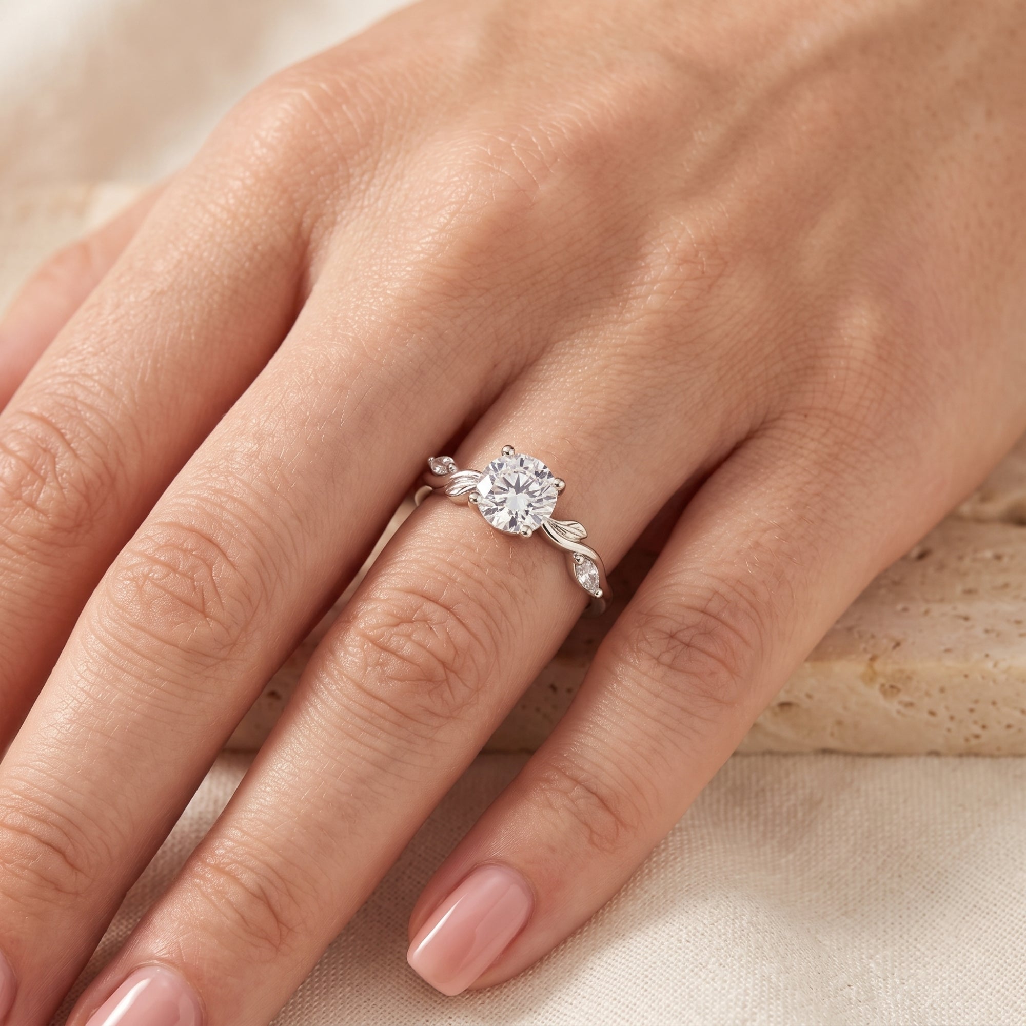 Round-cut simulated diamond Fidelia ring in sterling silver worn on a woman's finger.