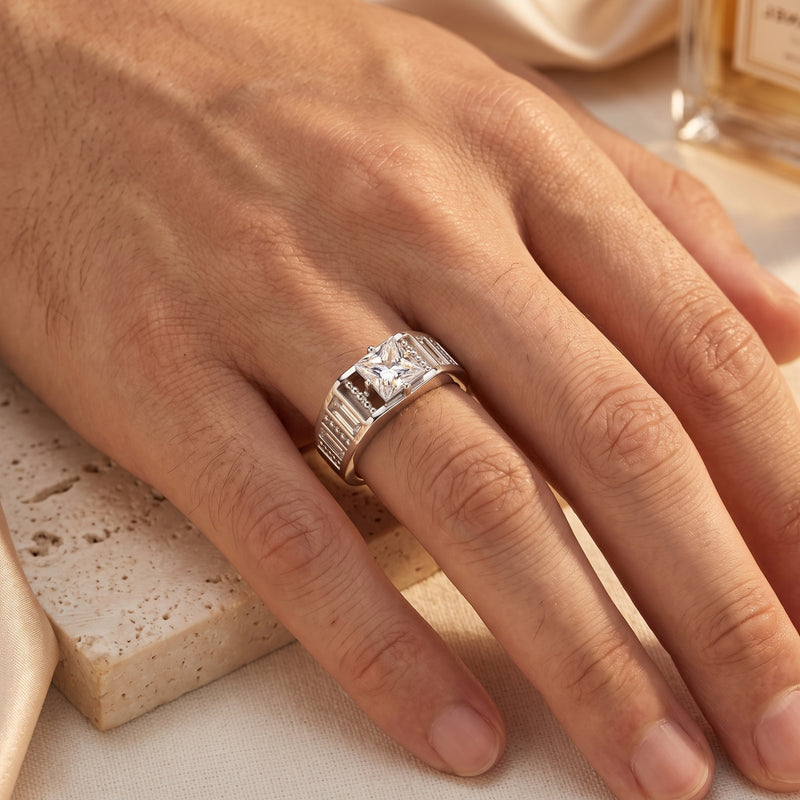 S925 sterling silver princess cut promise ring worn on a hand resting on a textured stone surface.