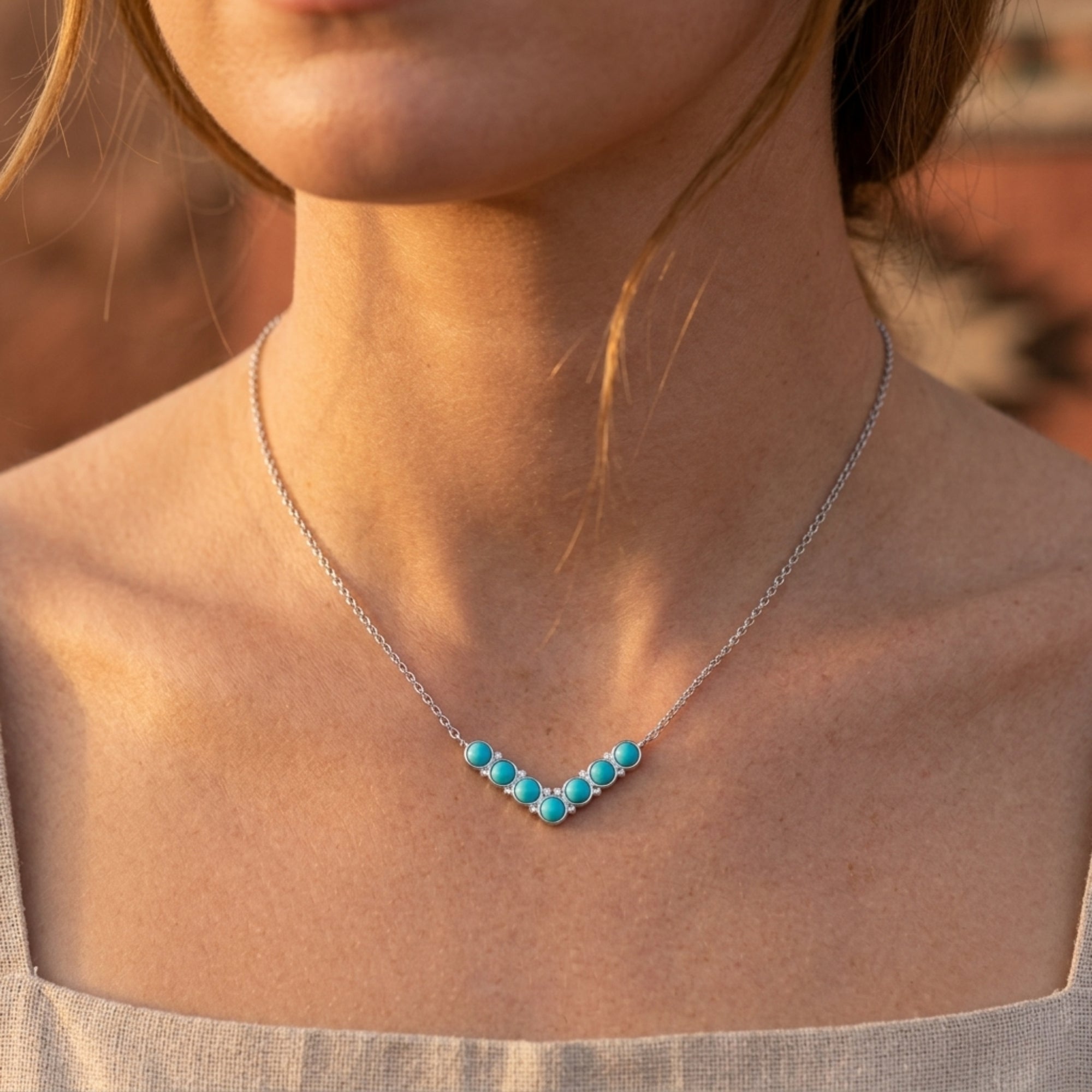 Mojave Sky turquoise bead necklace in silver worn on a woman's neck.