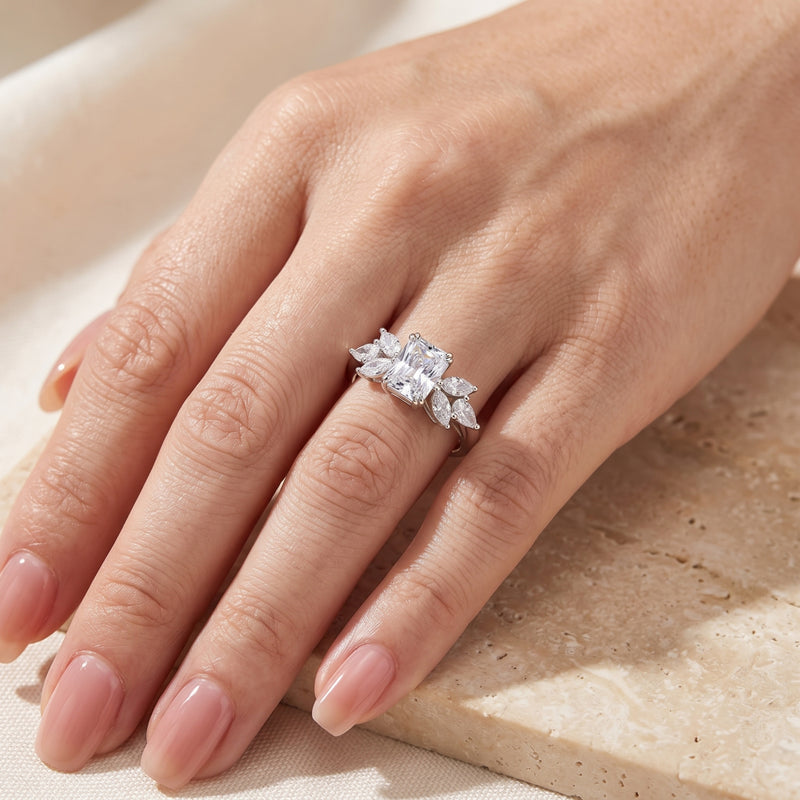Sterling silver Alandrelle ring with radiant cut simulated diamond worn on a woman's hand.