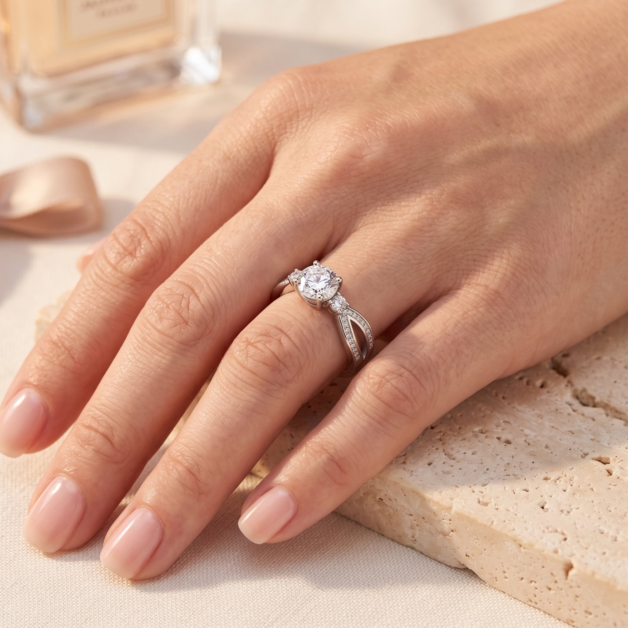 The Noeline sterling silver promise ring with a round cut simulated diamond worn on a woman's hand.