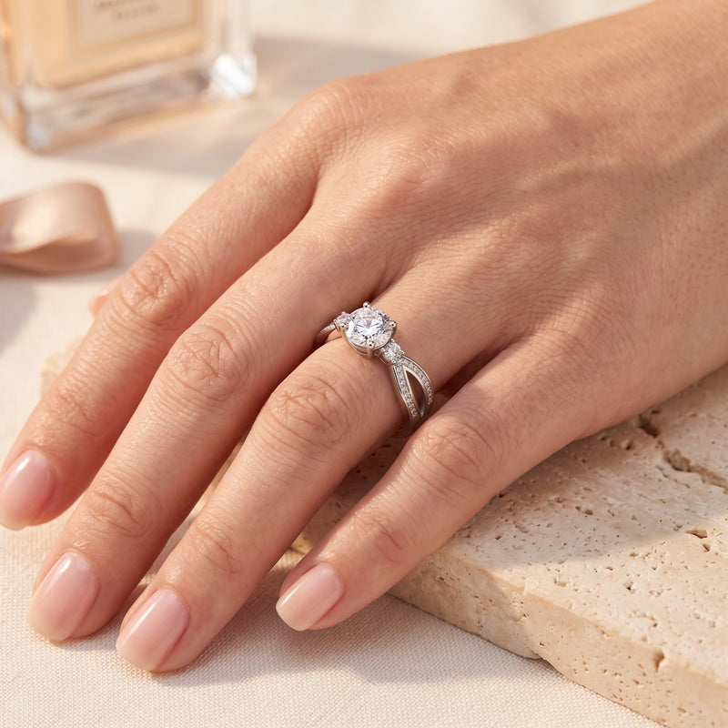 The Noeline sterling silver promise ring with a round cut simulated diamond worn on a woman's hand.