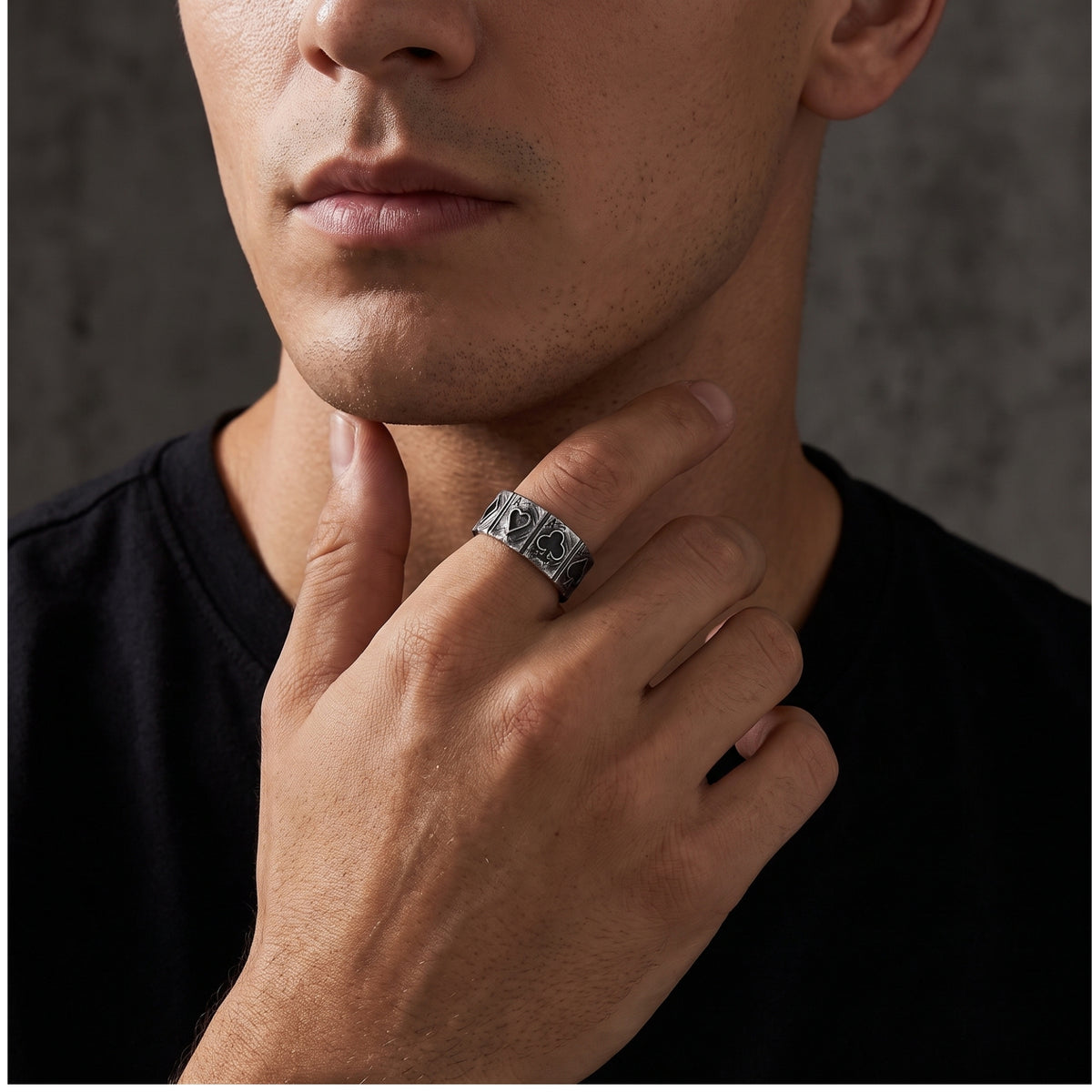 Close-up of a model wearing the silver four-aces open band ring near his jaw.