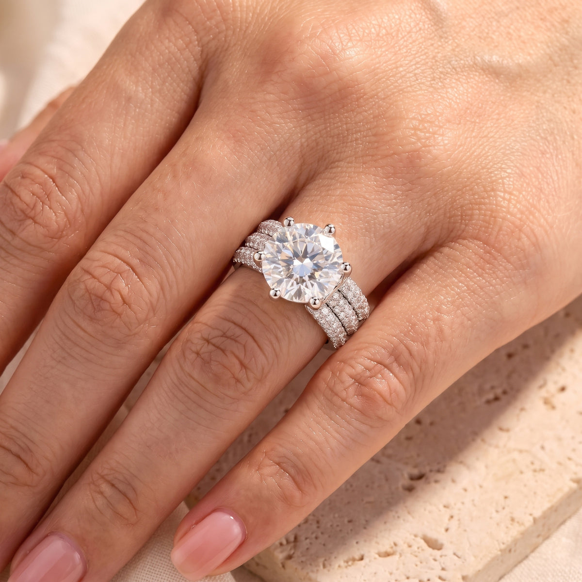 Sterling silver Sandrine ring with 11mm round simulated diamond worn on hand.