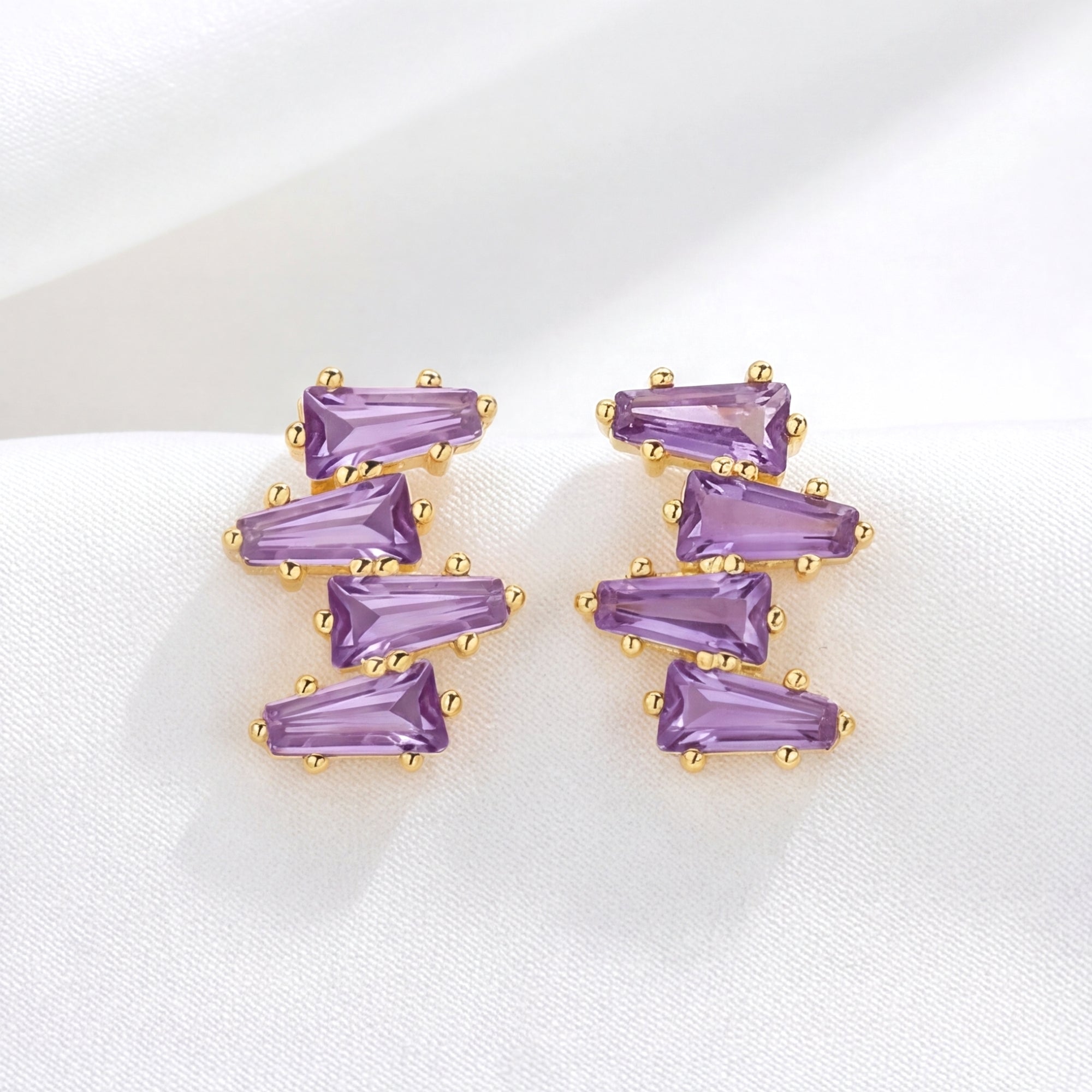 Front view of Callista cluster stud earrings in 18K gold vermeil with tapered baguette simulated amethyst.