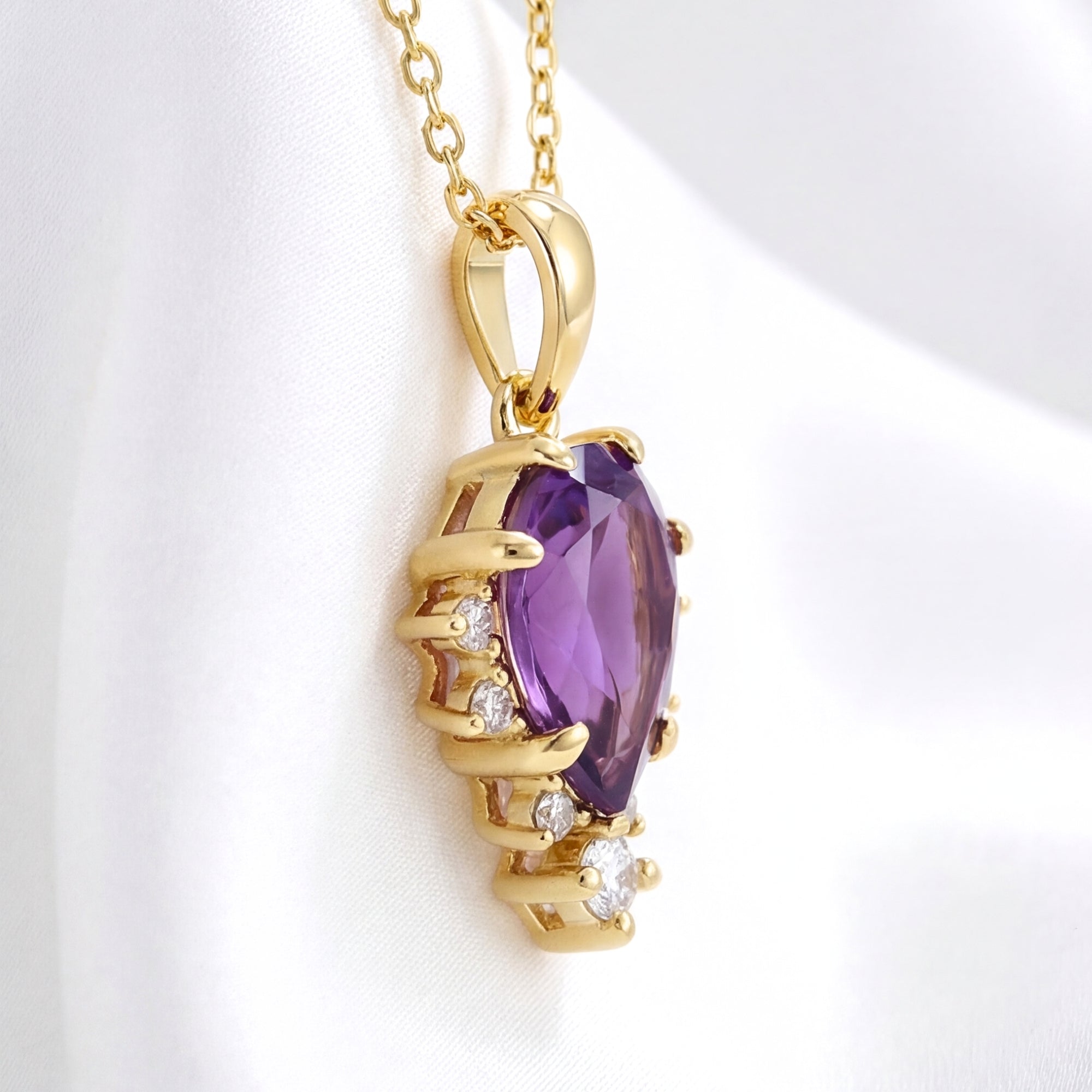 Side view of the pear cut simulated amethyst pendant in 18K gold vermeil showing the faceted setting.