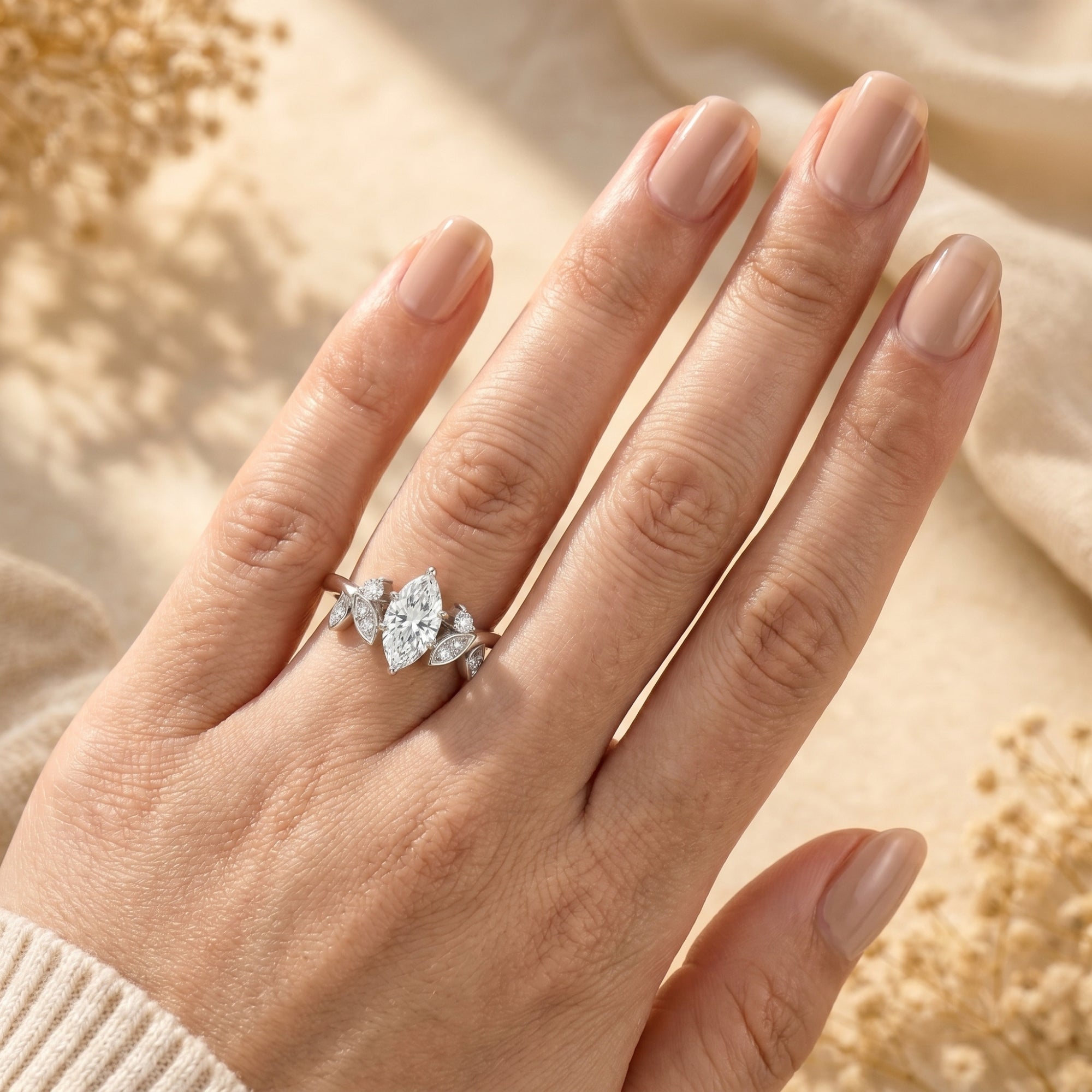 2CT marquise moissanite sterling silver ring worn on a woman's hand.