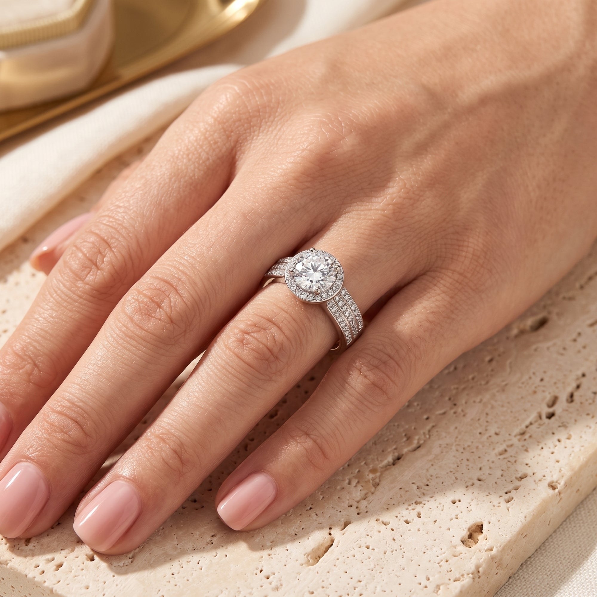 Women's S925 sterling silver simulated diamond halo ring worn on a model's hand.
