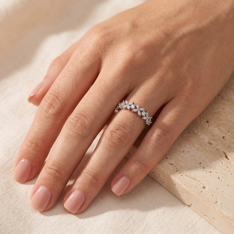 Silver marquise cut zircon floral promise ring worn on a model's hand.