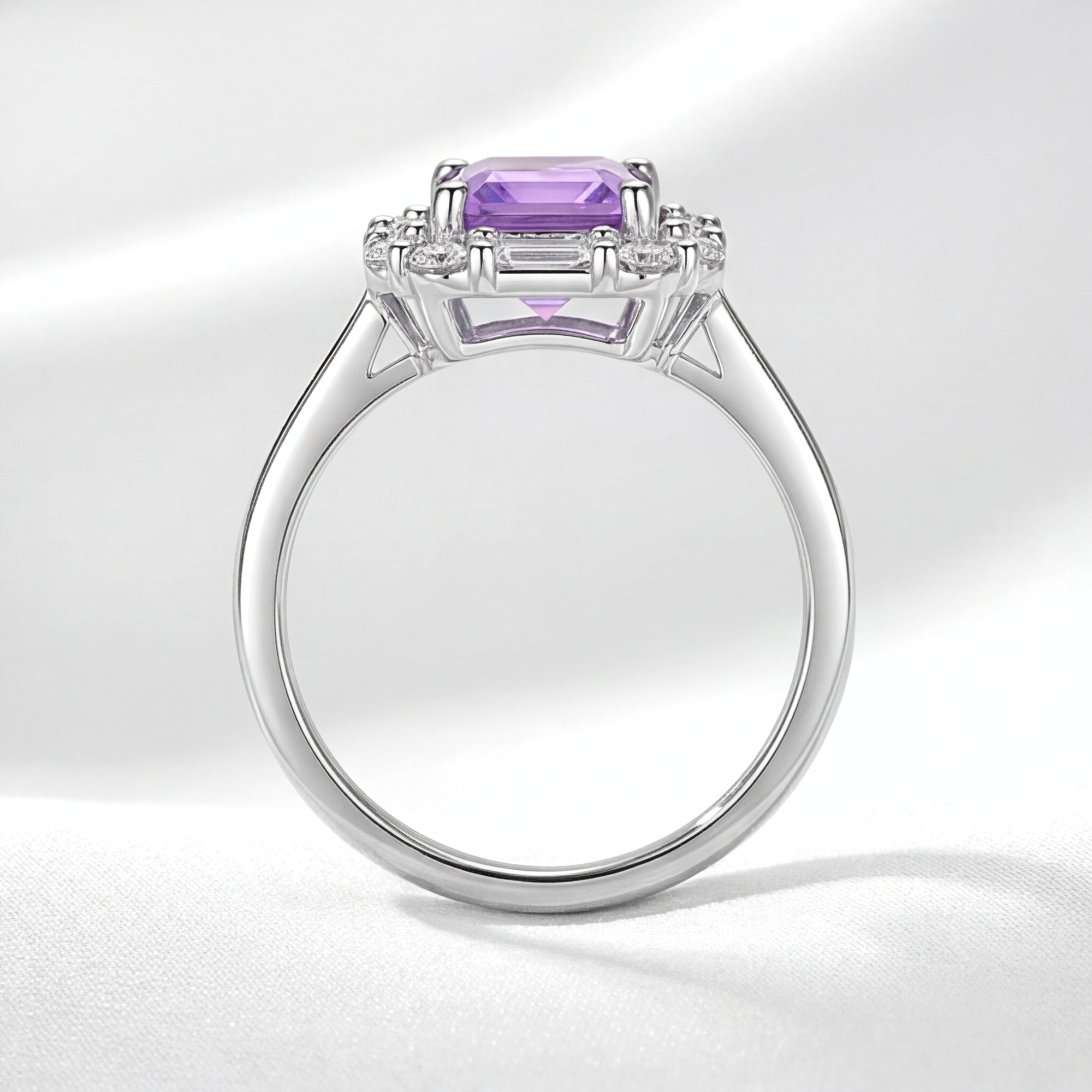 Side profile of the S925 sterling silver Veridiana halo ring with an emerald cut simulated amethyst.