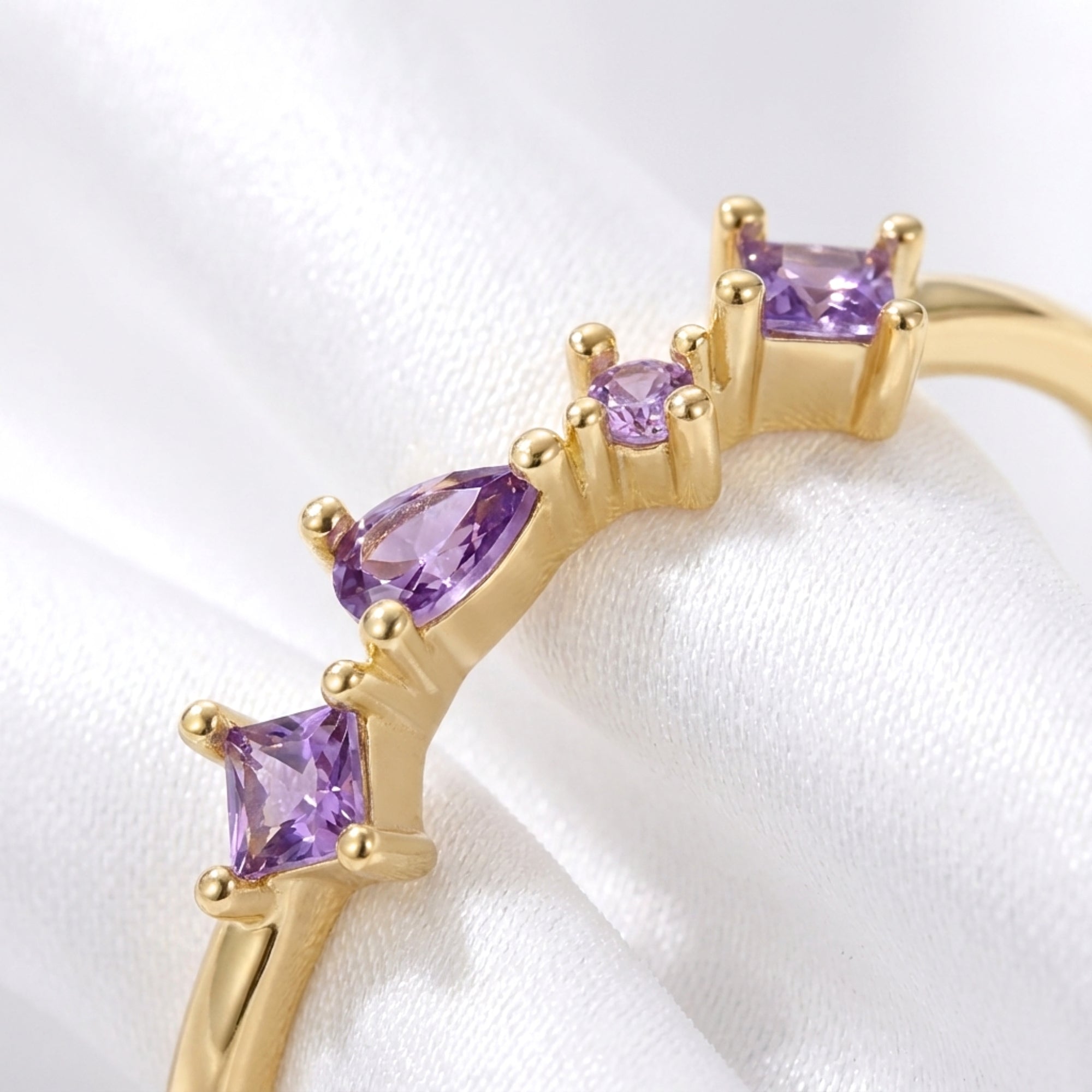 Macro view of the princess and pear cut simulated amethyst stones on the Elisia gold vermeil ring.