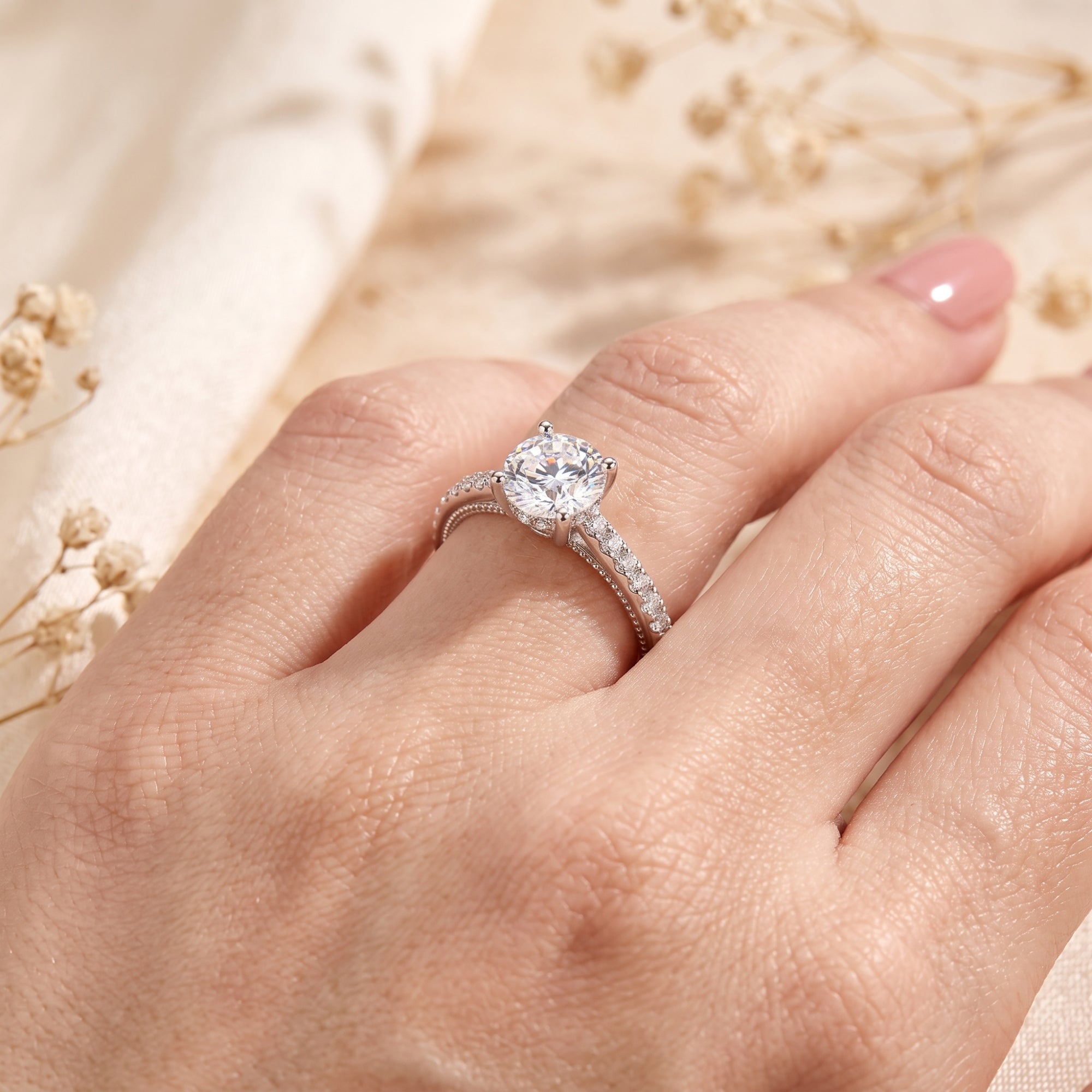 Calliandra sterling silver promise ring with a round-cut simulated diamond worn on a model's finger.