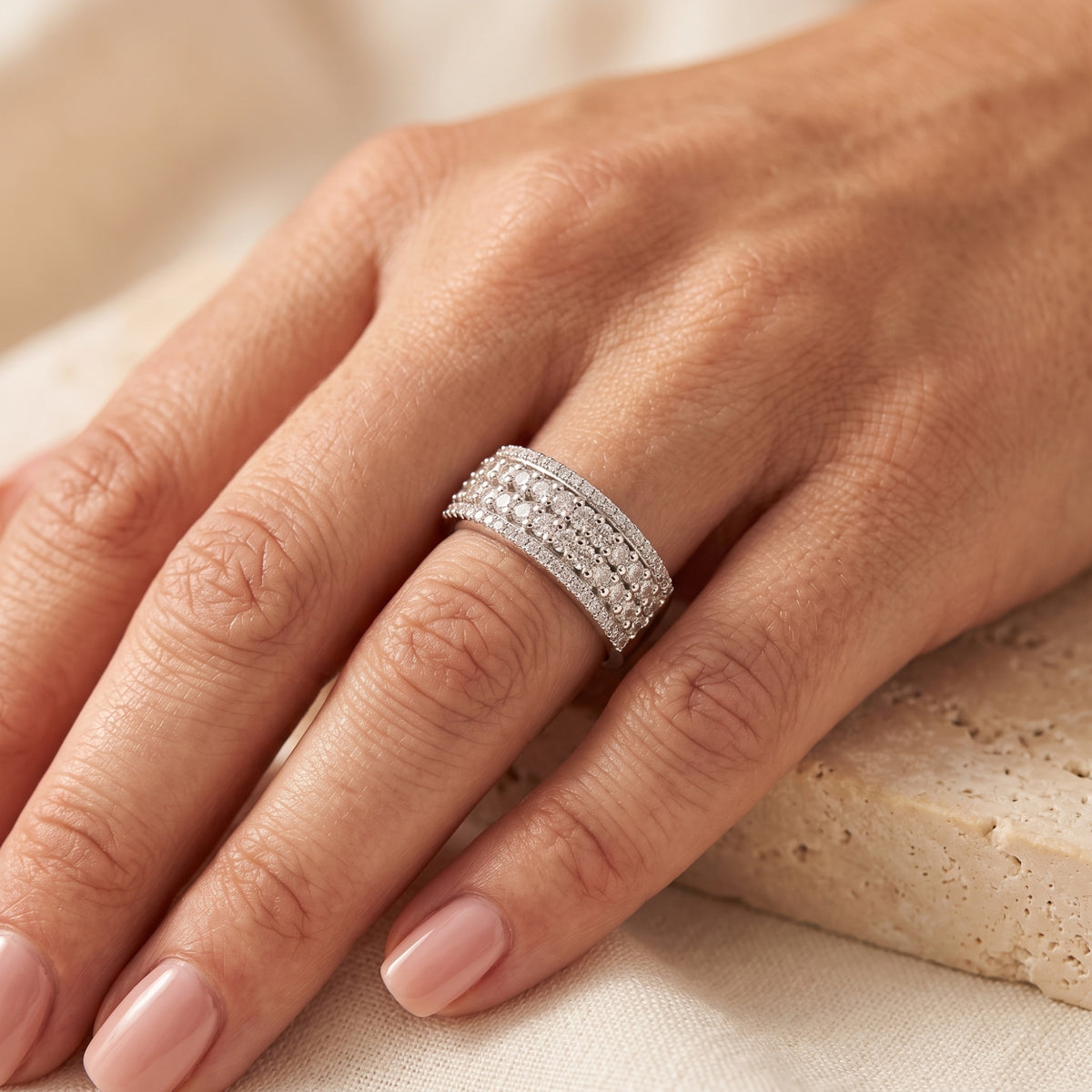 Wide sterling silver multi-row cubic zirconia ring worn on a woman's hand.